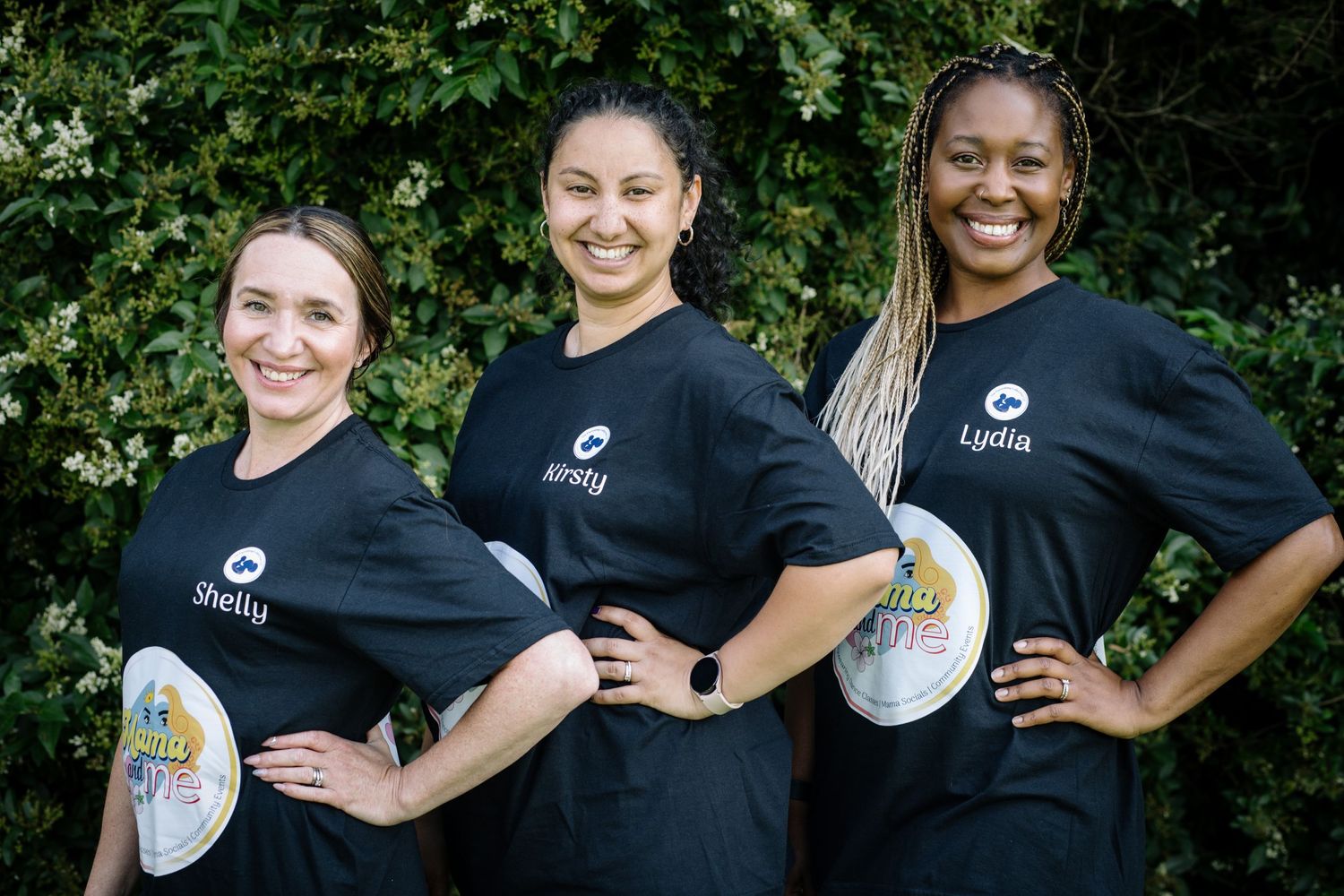 Three team members in matching black uniforms pose confidently outdoors with rugby balls.