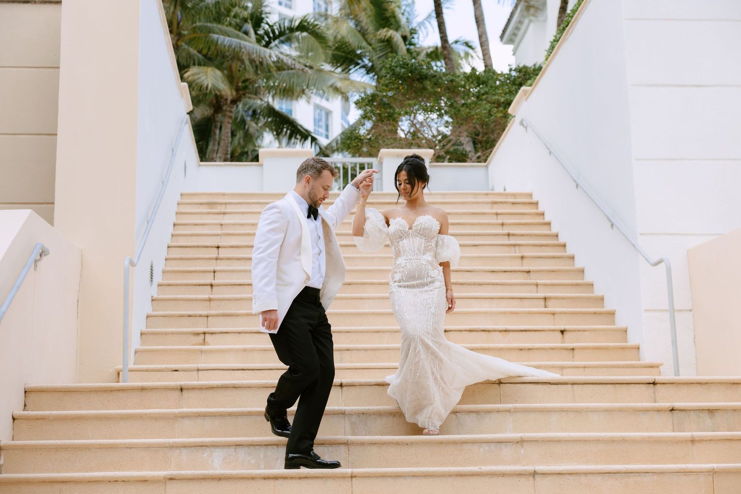 Bride and groom walking down stairs at The Bath Club Miami Beach