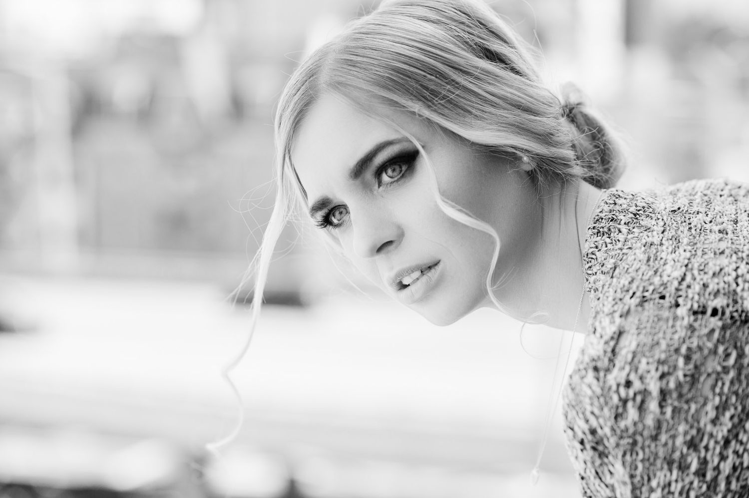 Black and white portrait of blonde woman with elegant updo hairstyle.