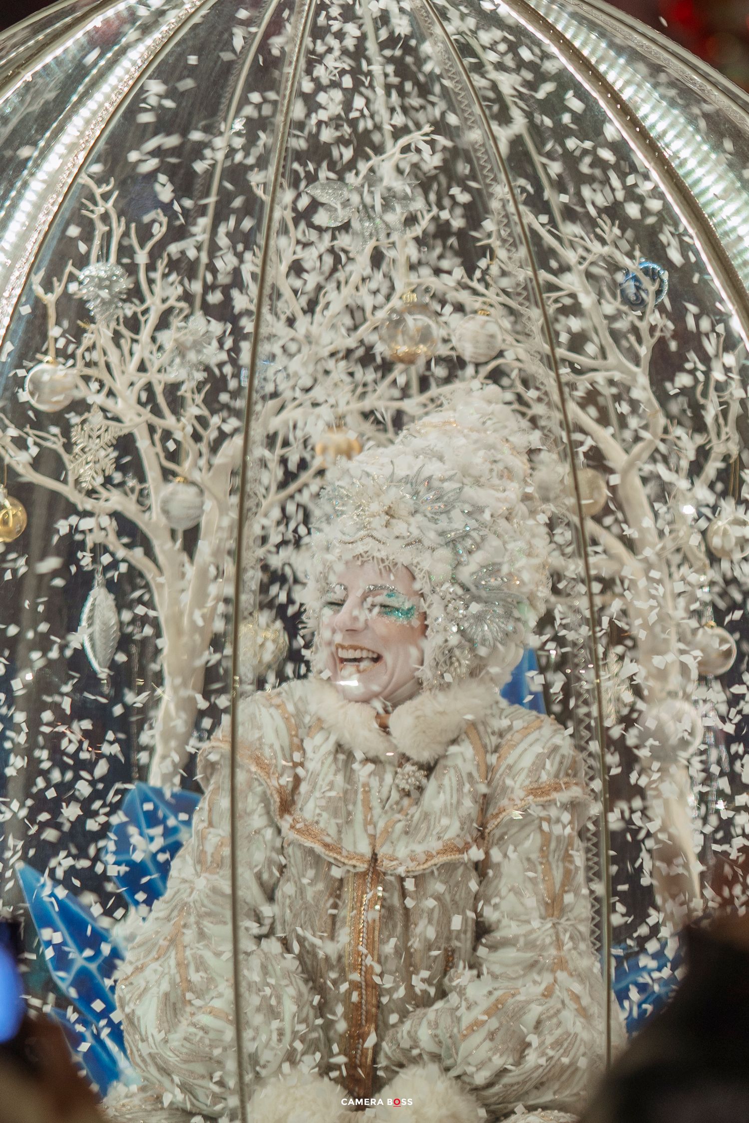 A figure covered in white foam or soap suds stands beneath an ornate domed ceiling with intricate patterns.