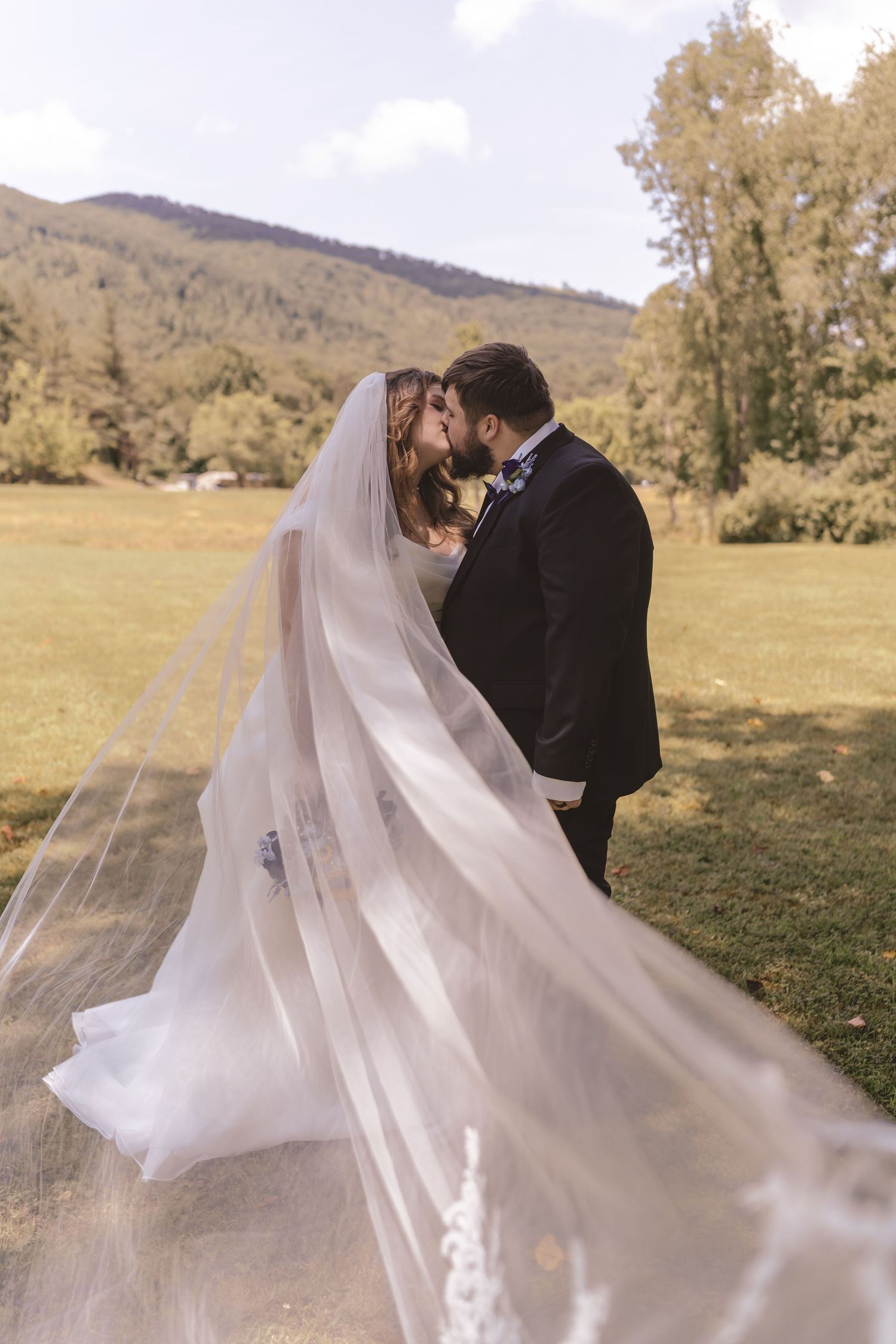 Bride and groom kissing with mountain views at Nottingham Church in Gate City, VA