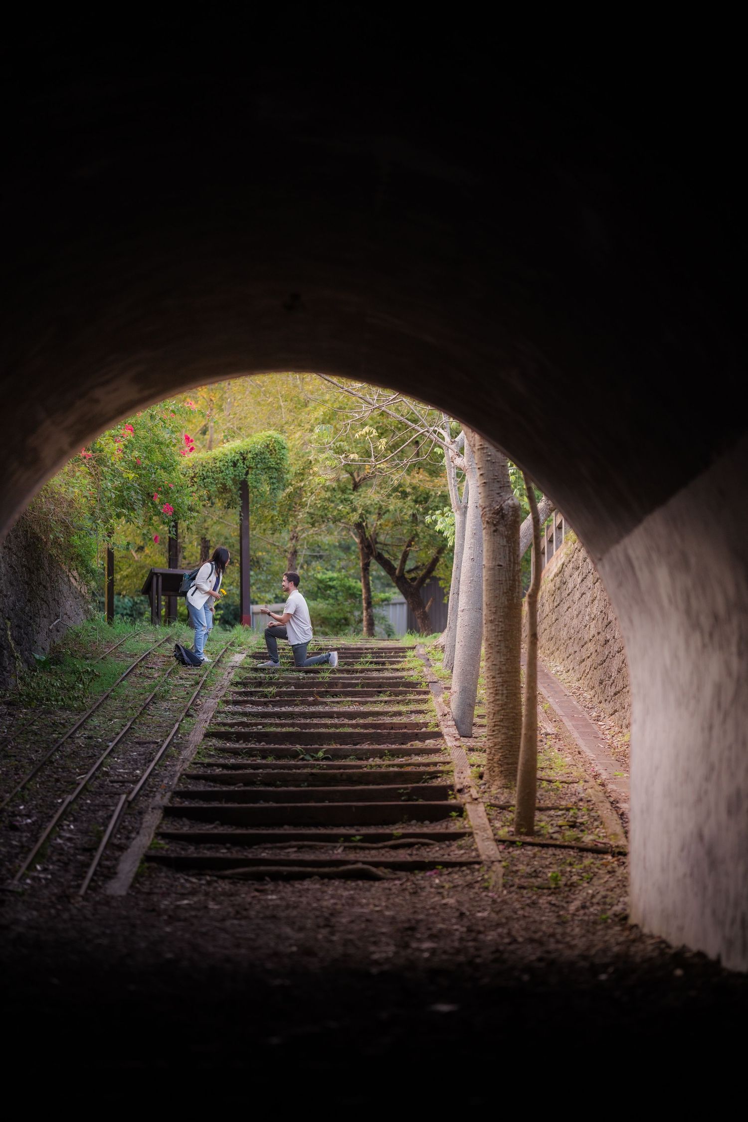A sequence of photos showing a stone tunnel or underpass with steps leading upward into daylight and greenery.