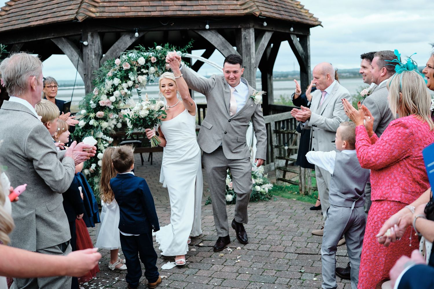Wedding guests dancing and celebrating together on an outdoor patio during a festive reception party at The Ferry House, Sheerness.