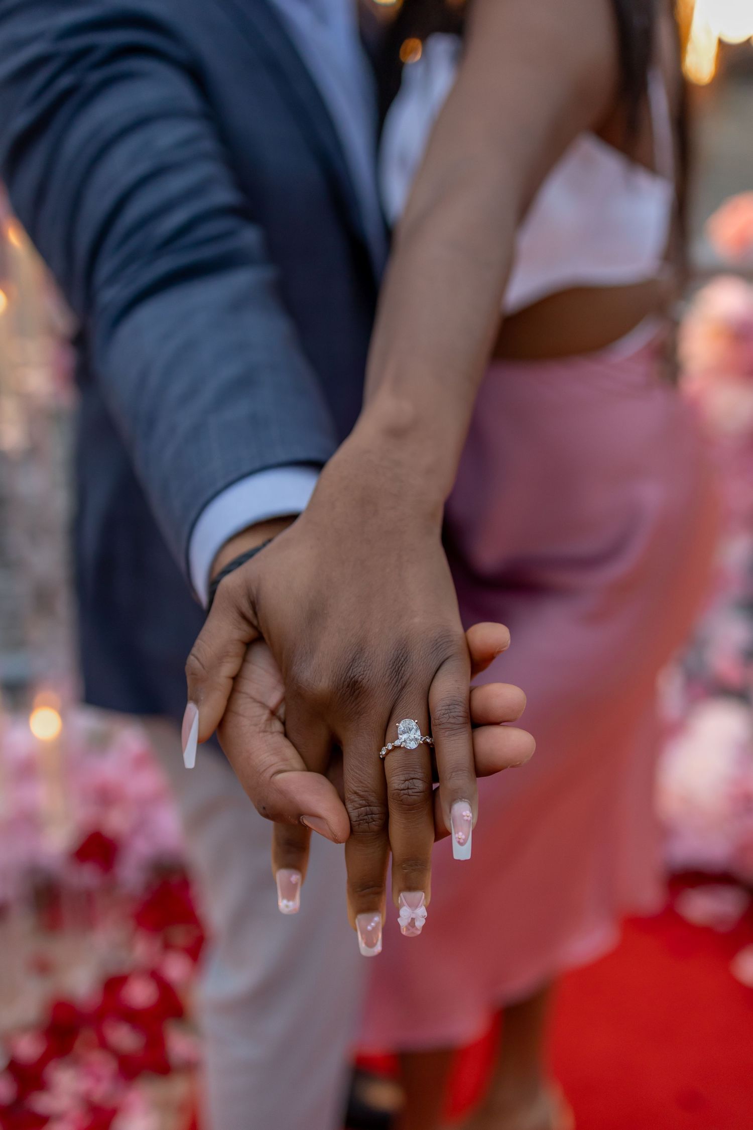 Close-up view of hands exchanging small black and white polaroid photographs in a casual setting.