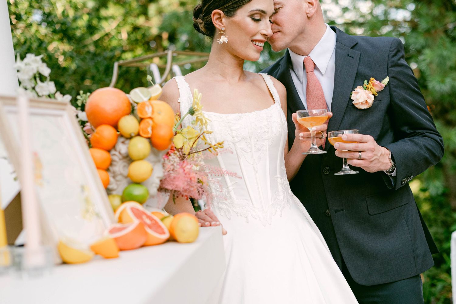 A outdoor Ceresville Mansion wedding ceremony scene with lush greenery, white pillars and floral arrangements creating an elegant backdrop.