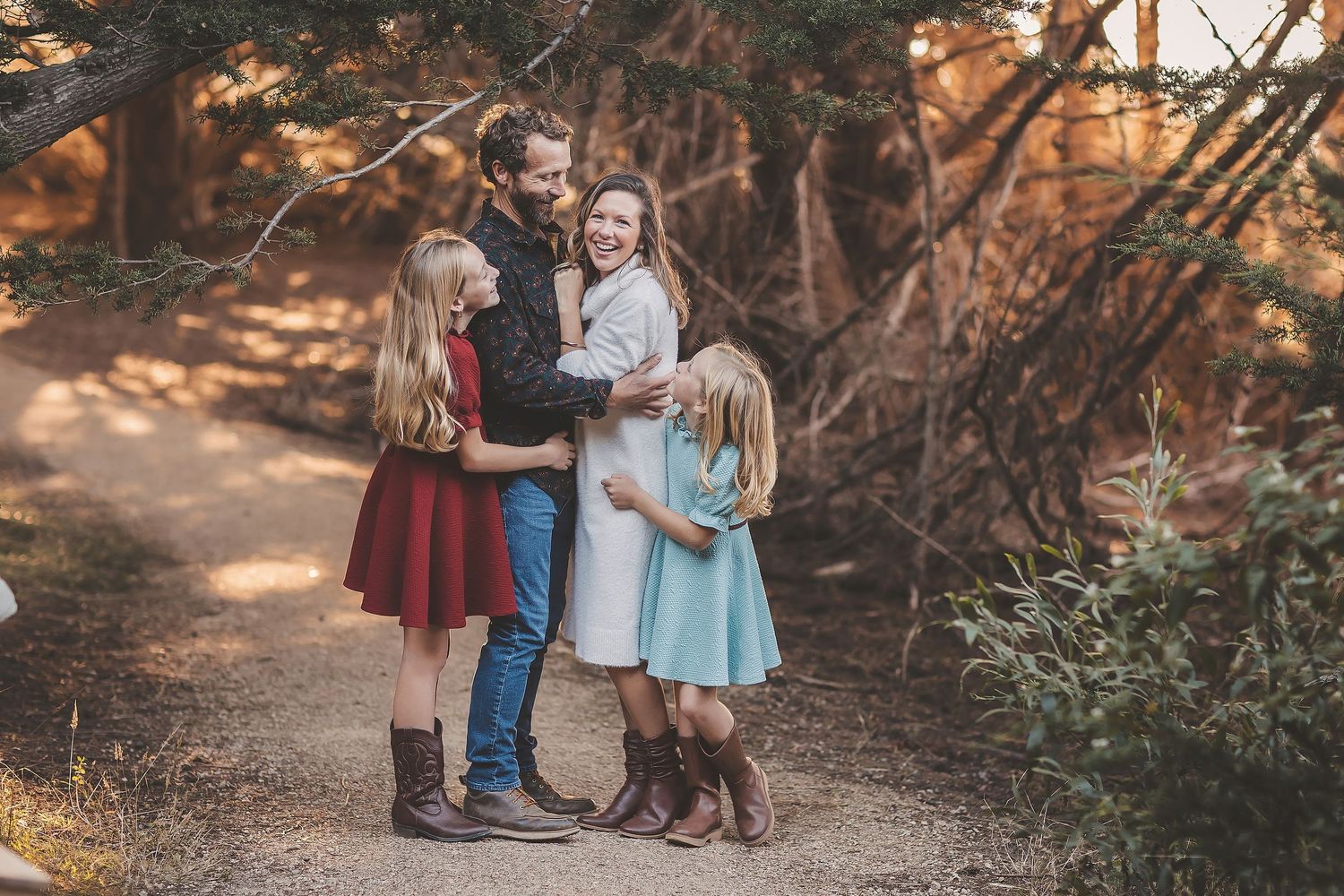 A series of outdoor family portrait photos taken in a wooded setting during autumn with warm natural lighting.