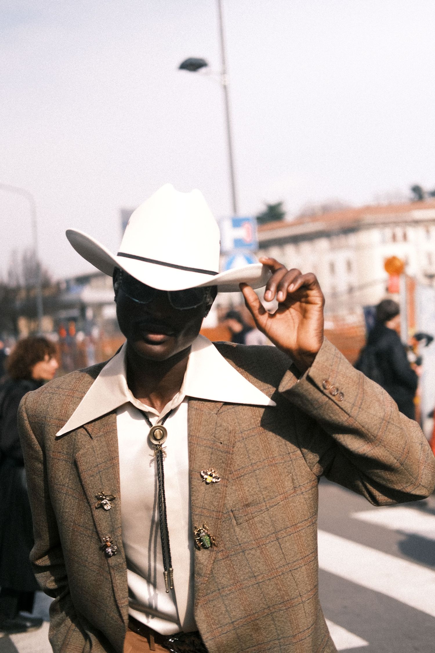 A row of silhouetted cowboy hats against a light background creates a striking pattern of western style.