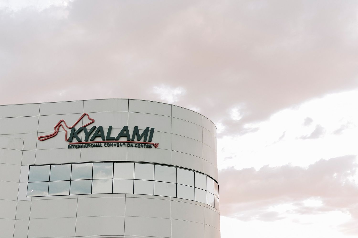 Kyalami International Convention Centre building exterior with logo against cloudy sky.