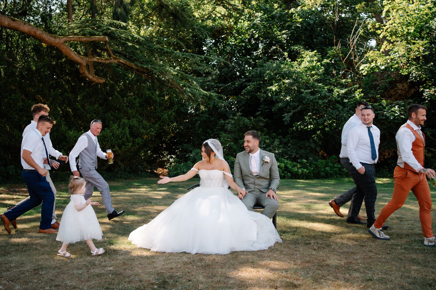 Couple enjoying photo roulette together at cocktail hour with their guests leaving and arriving for quick fun photographs on a wedding day