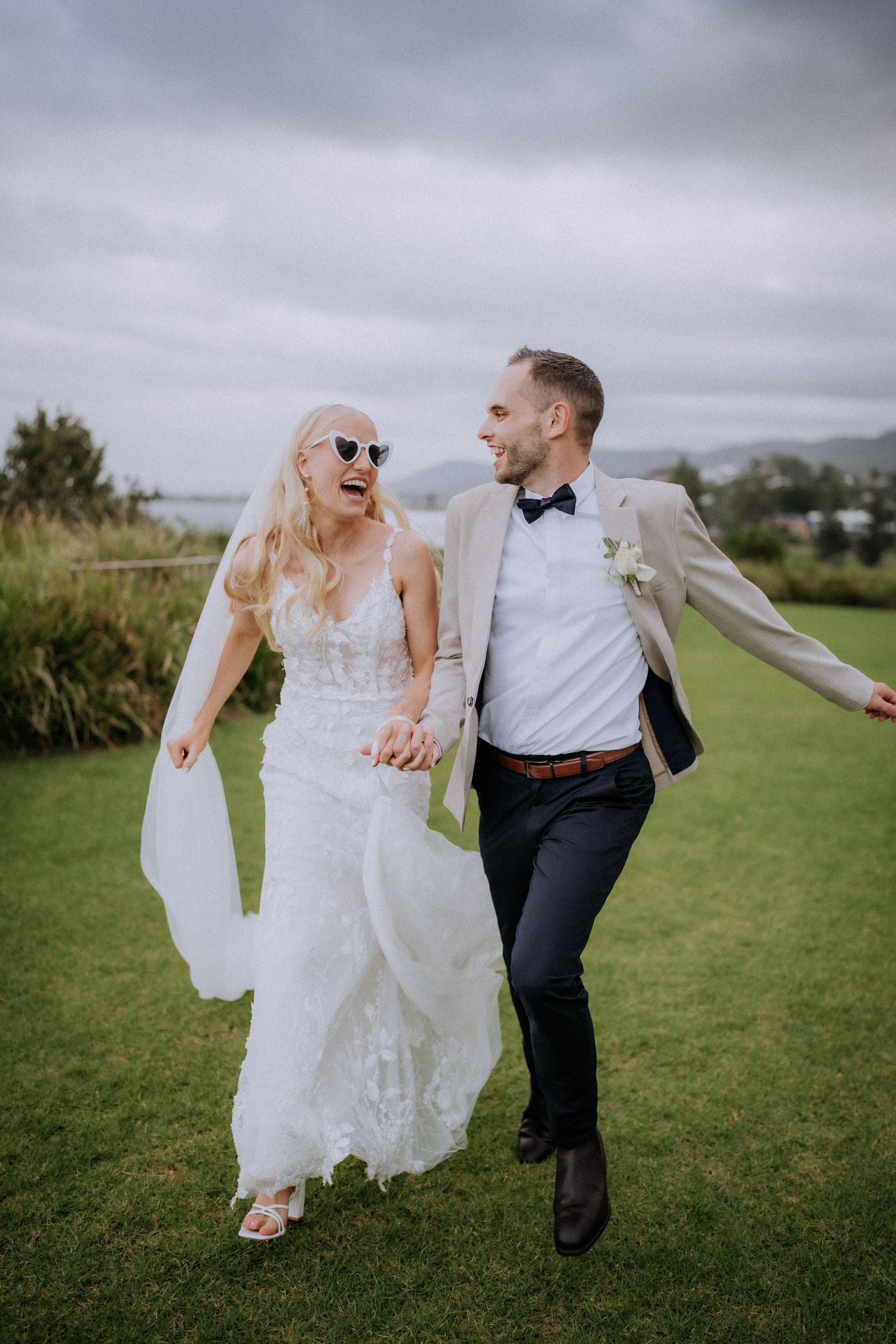 Wedding exit celebration with guests creating sparkler tunnel for dancing couple.