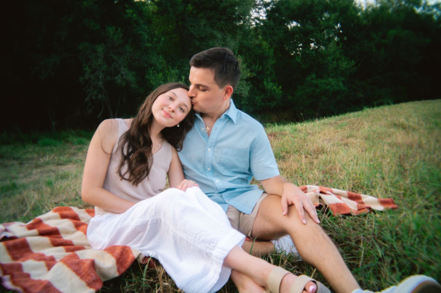 Newly engaged couple posing for their engagement photos at Purgatory Creek Natural Area in San Marcos, Texas
