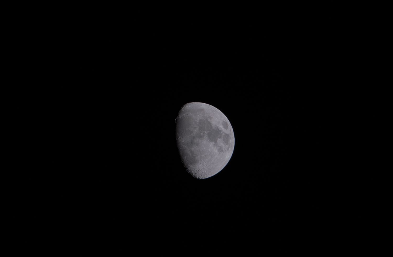Six progressive phases of a waning moon show the lunar surface gradually darkening from full to crescent.
