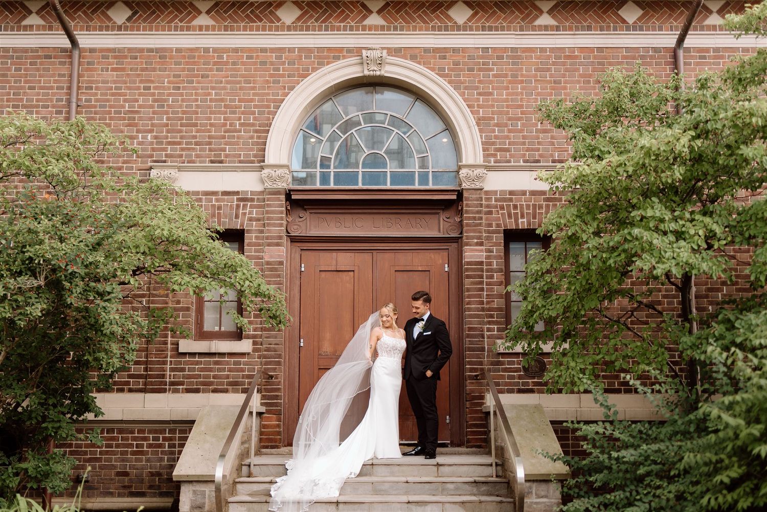 A wedding couple stands on the steps of the historic MacLaren art centre in Barrie.