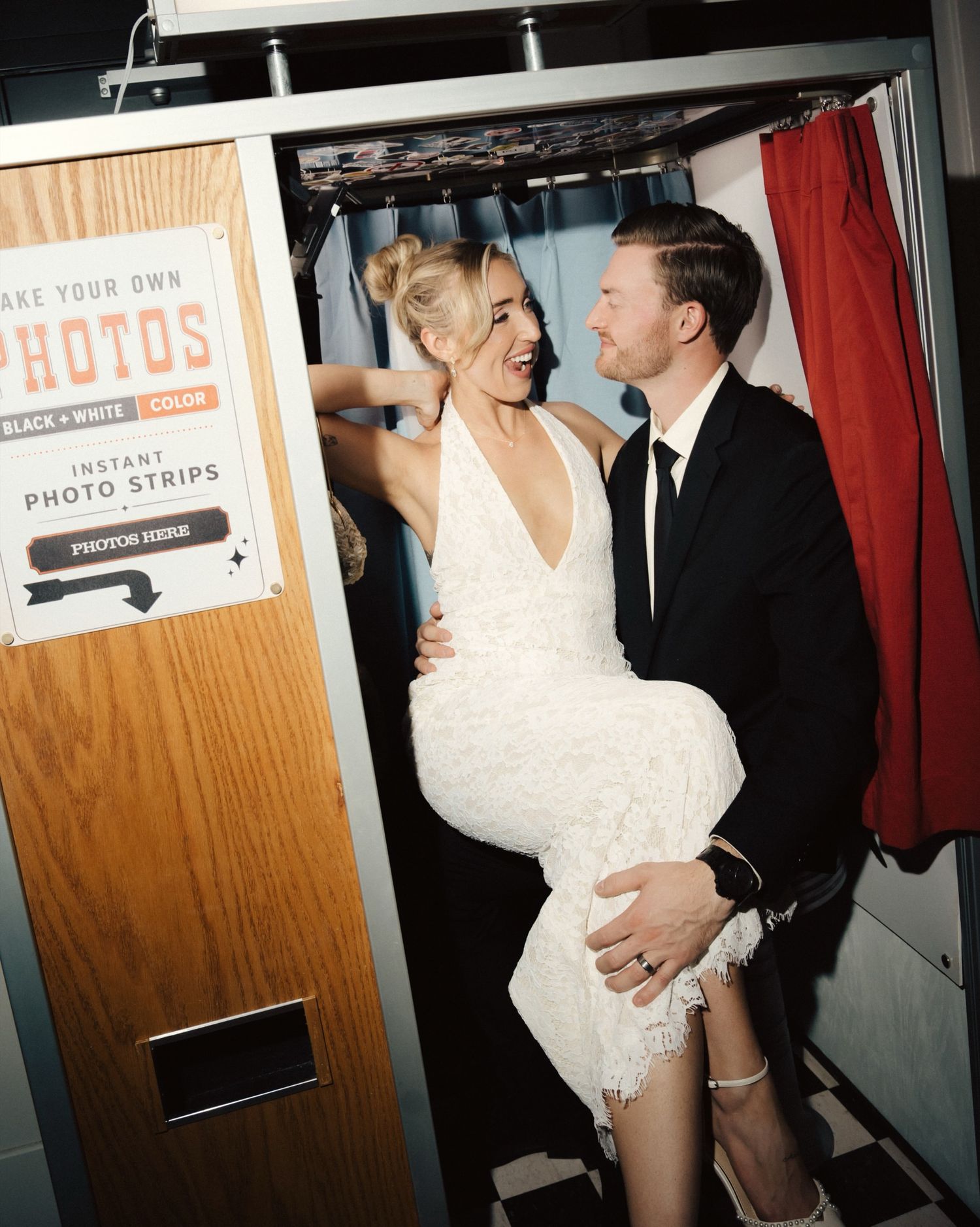 Guests in an enclosed vintage photo booth at a Calgary wedding