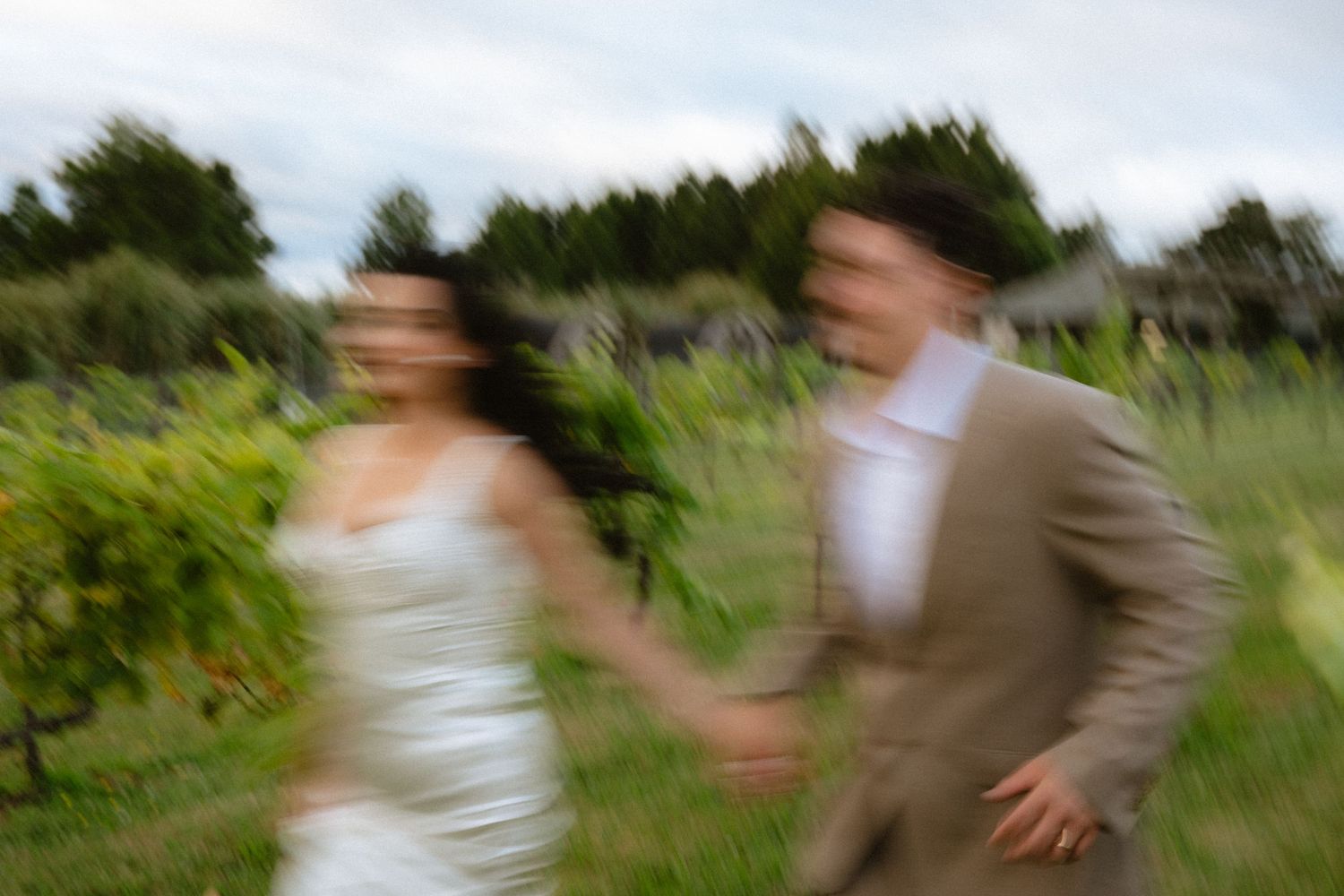 Delicate white veil flows in the breeze during an outdoor wedding ceremony.