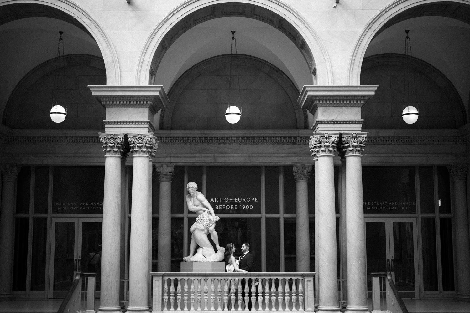 Classic arched colonnade with ornate pillars and architectural details in black and white.
