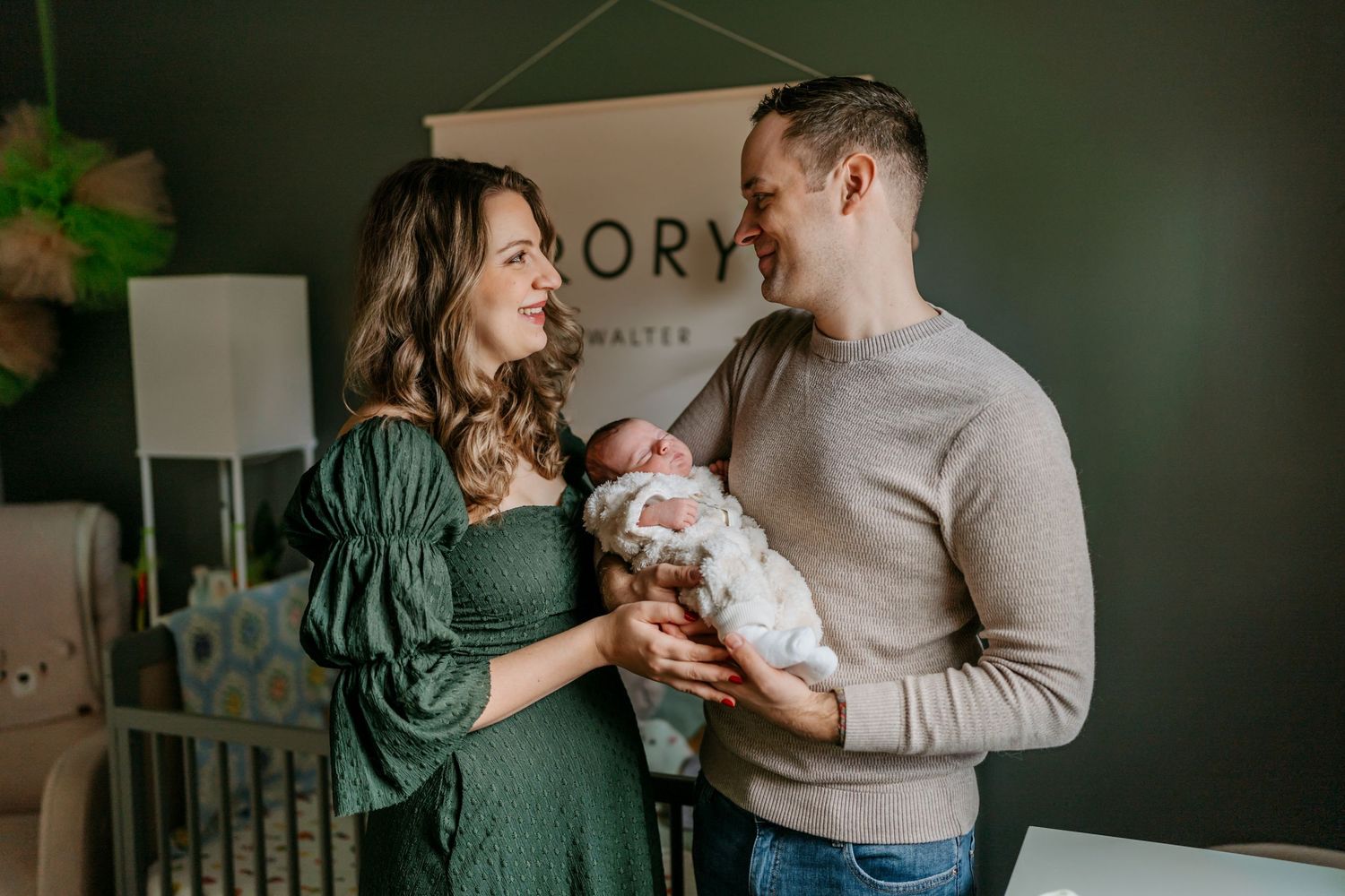 Intimate family moment captured in studio with Story Photography branding visible.