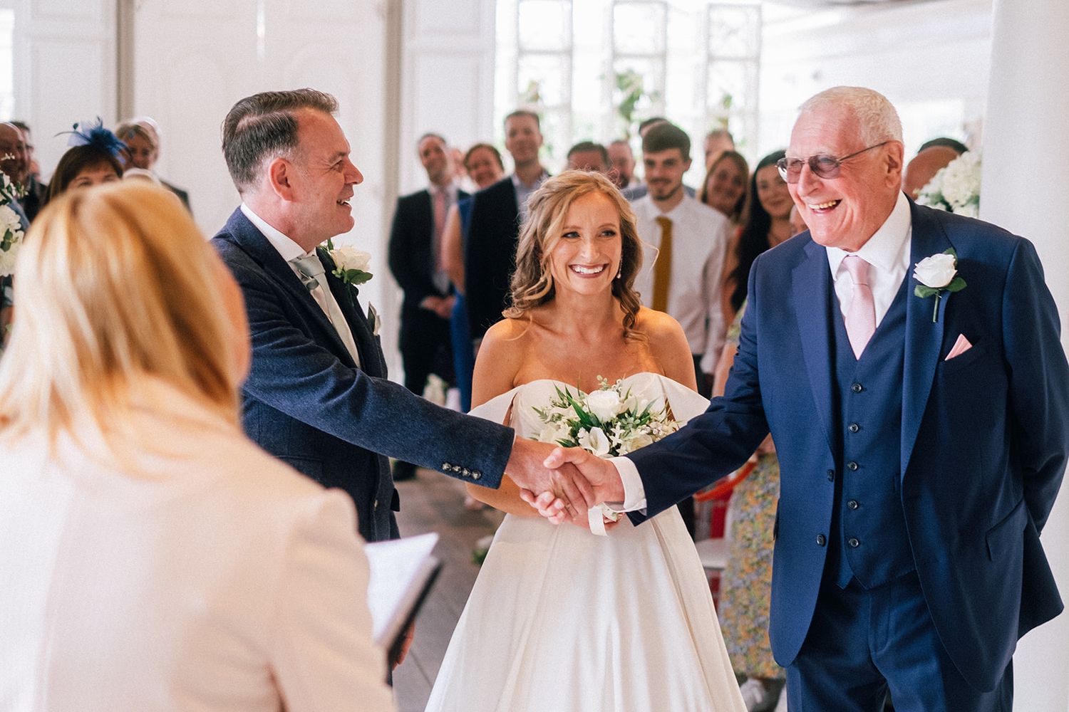 Joyful celebration with confetti shower at outdoor wedding ceremony.