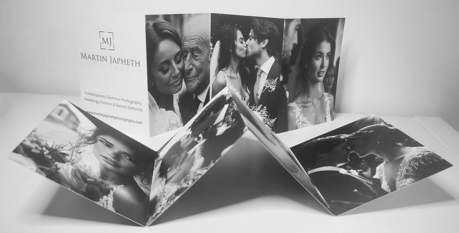 Black and white accordion-style photo album displaying wedding moments.