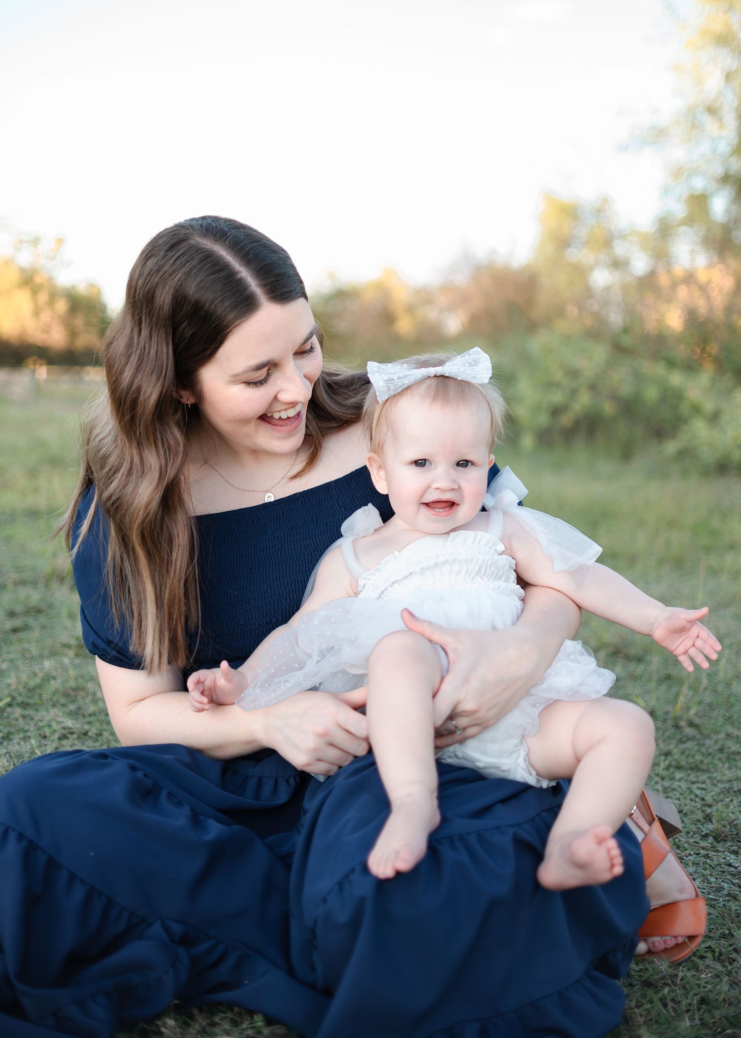 Mother holding baby during outdoor family session at Salado Creek in Salado Texas