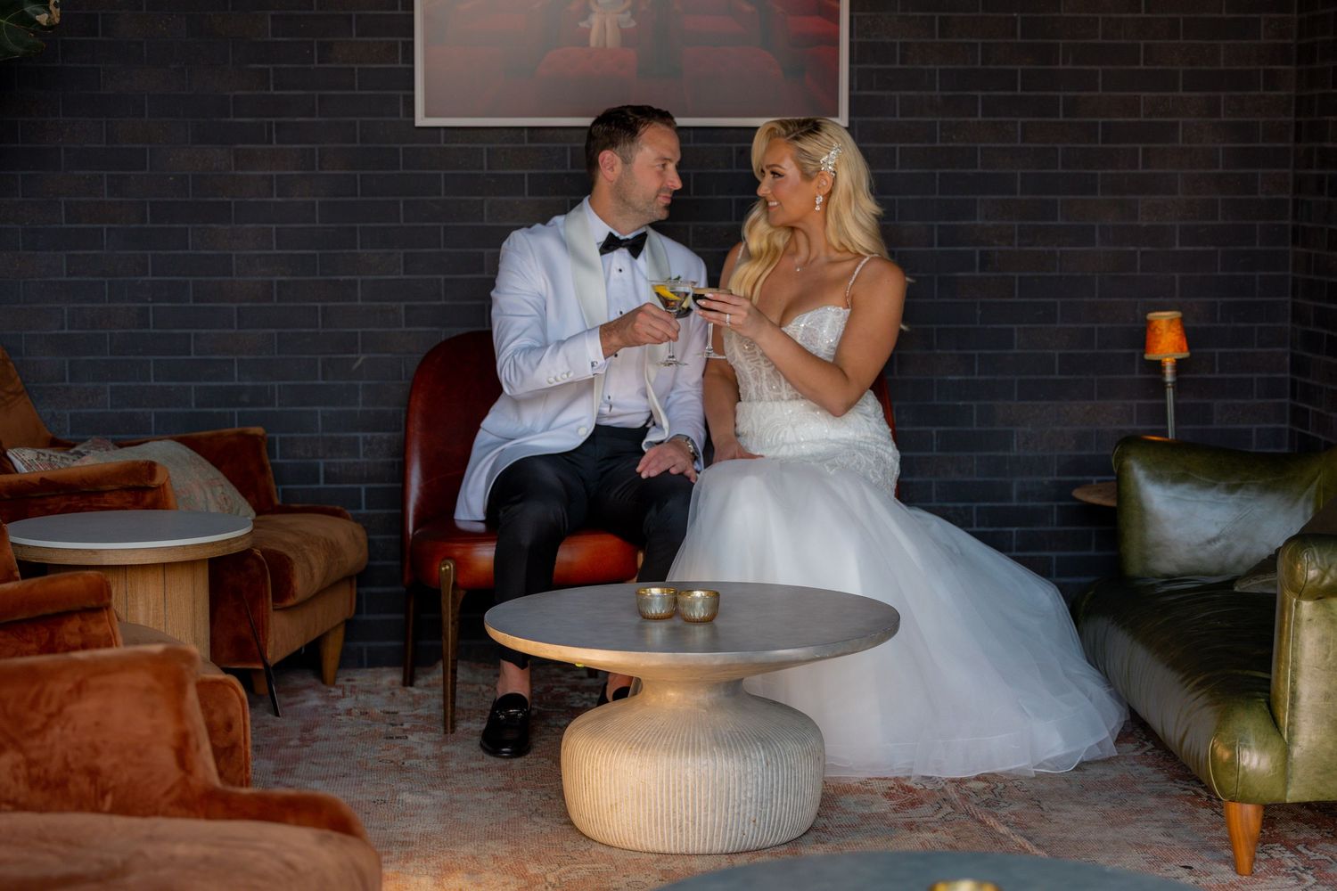 Bride and Groom having their first signature drink on a rooftop bar in Detroit Michigan Book Tower.
