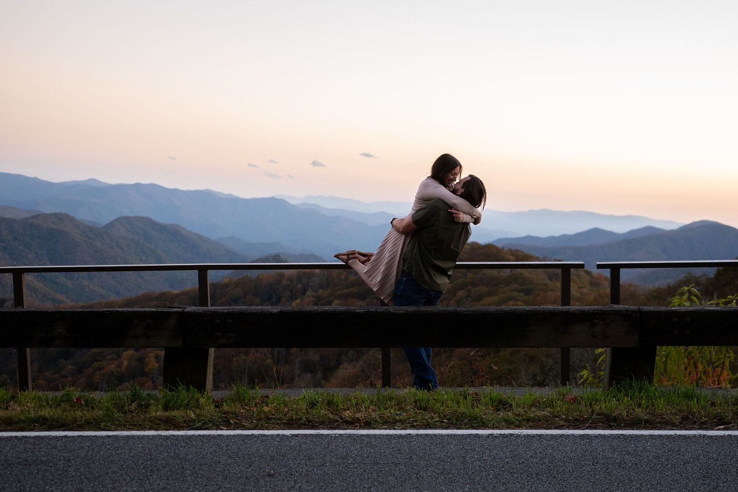 A panoramic sequence of silhouettes against a mountain landscape at sunset with wooden fence in the foreground.