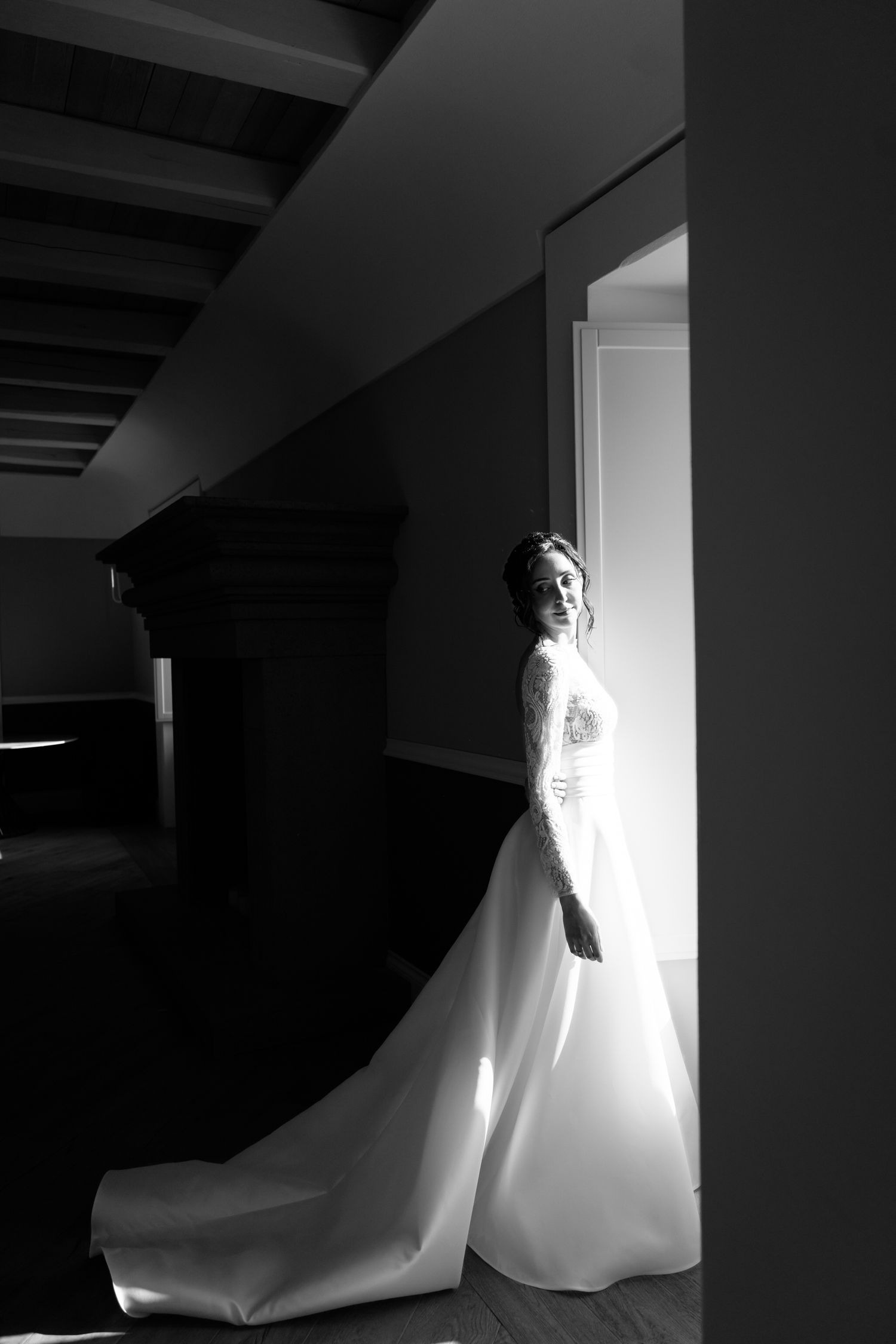 A dramatic sequence of black and white photos showing a figure in white moving through a doorway in darkness.