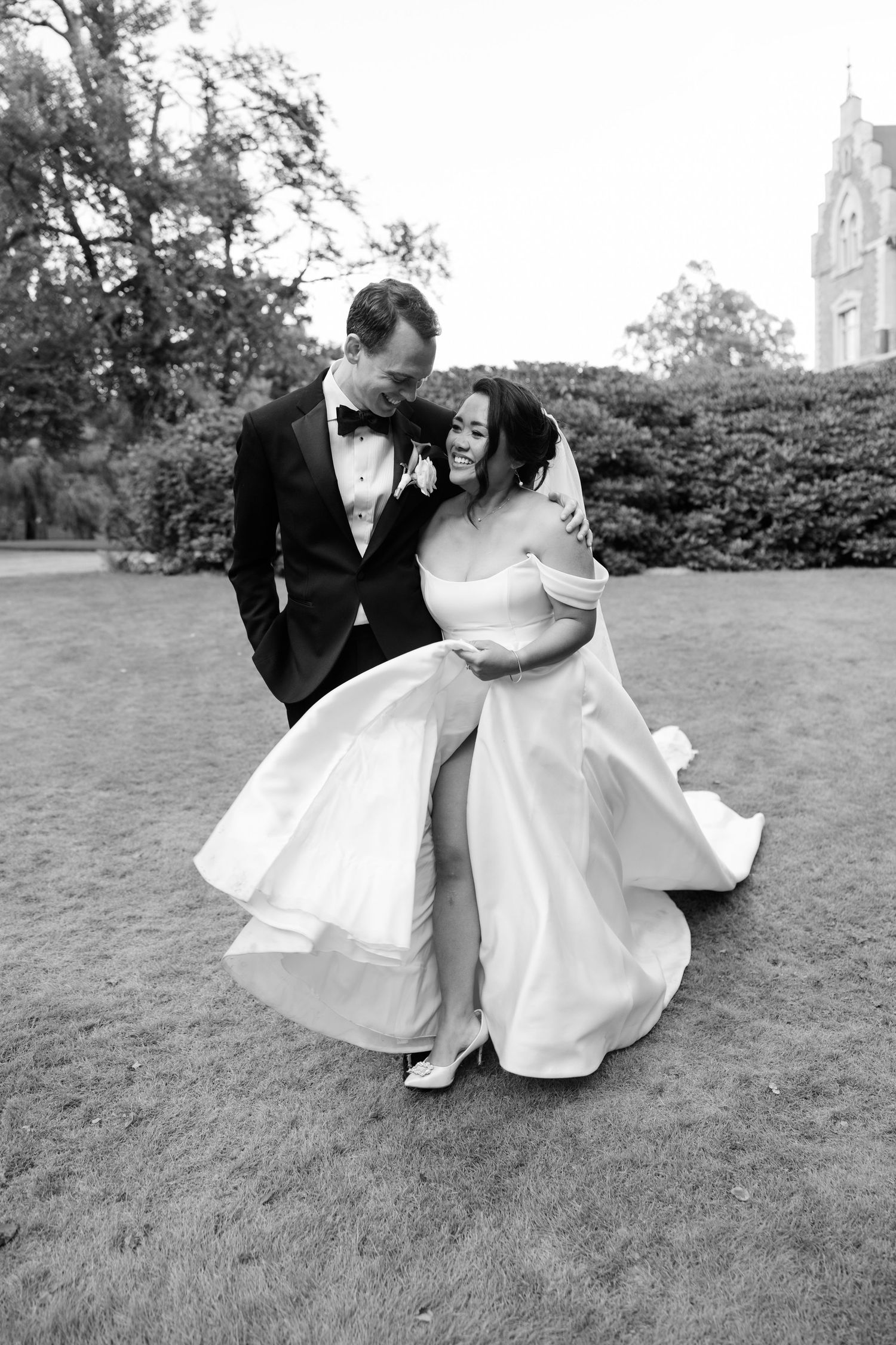 A romantic black and white wedding photo series shows a couple dipping and dancing together on a grassy lawn.