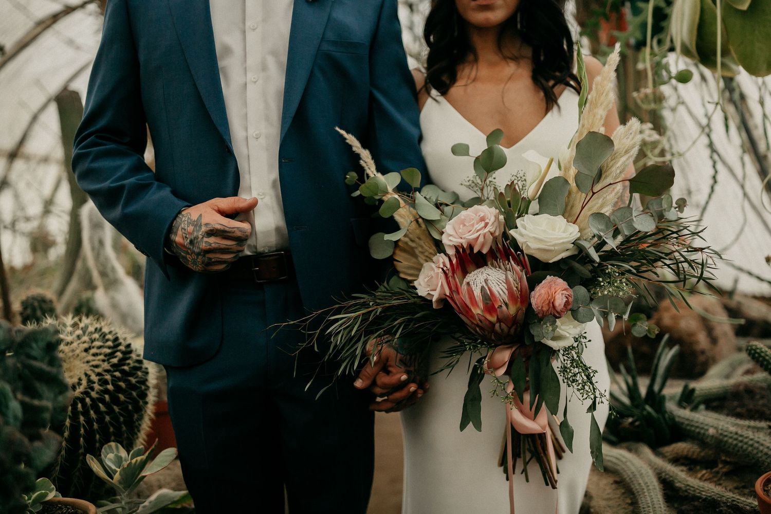 Wedding attire and floral bouquet details featuring white roses and greenery.