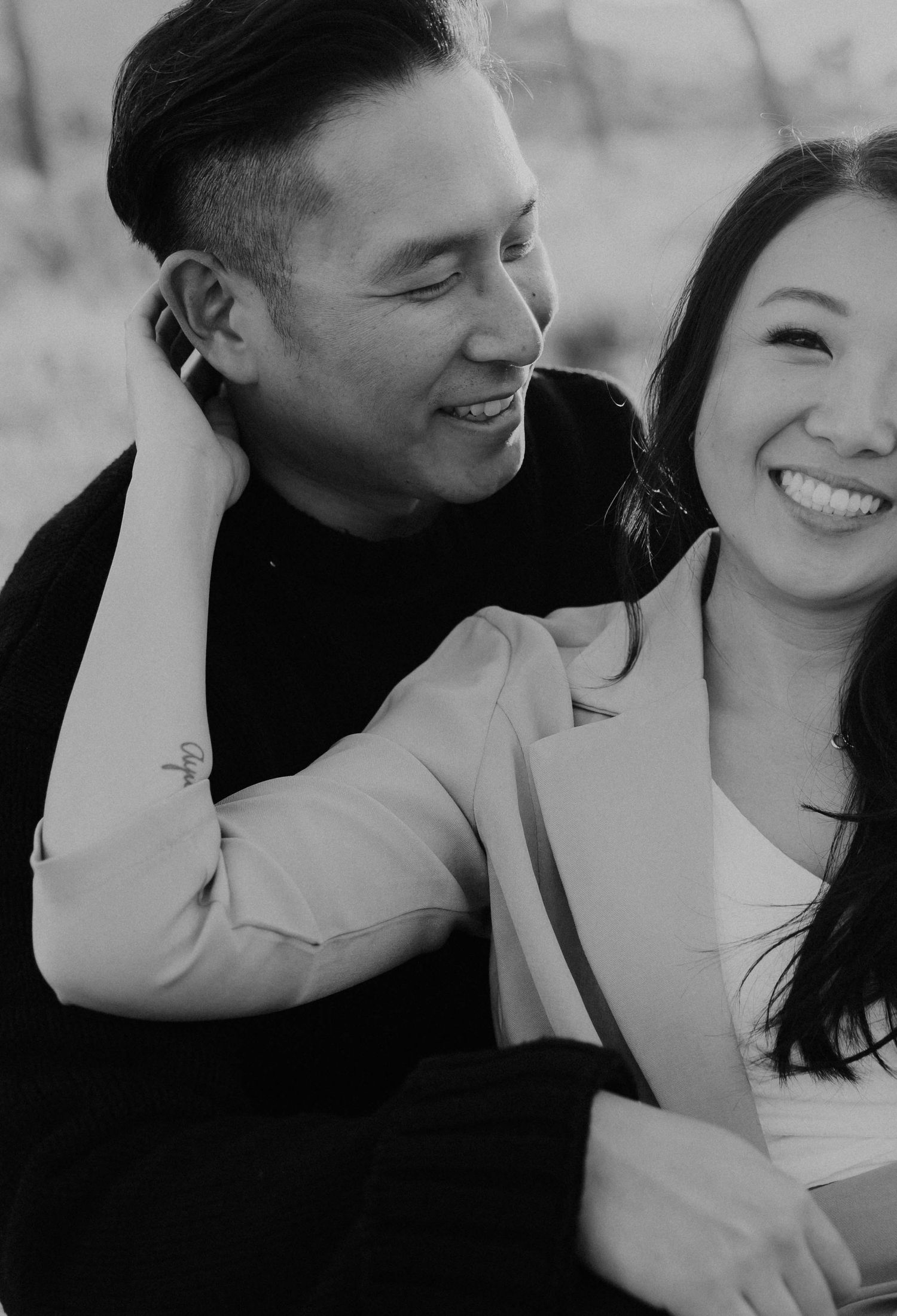 Intimate black and white portrait of couple sharing genuine laughter together.