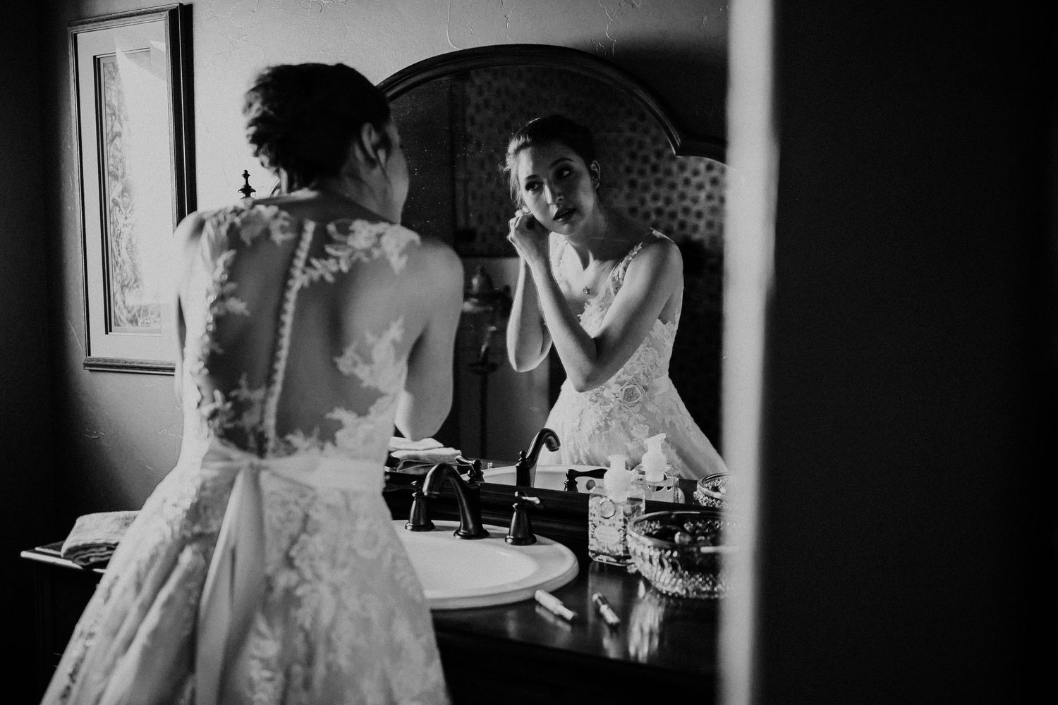 A series of four black and white wedding photographs showing tender moments during preparation and celebration.