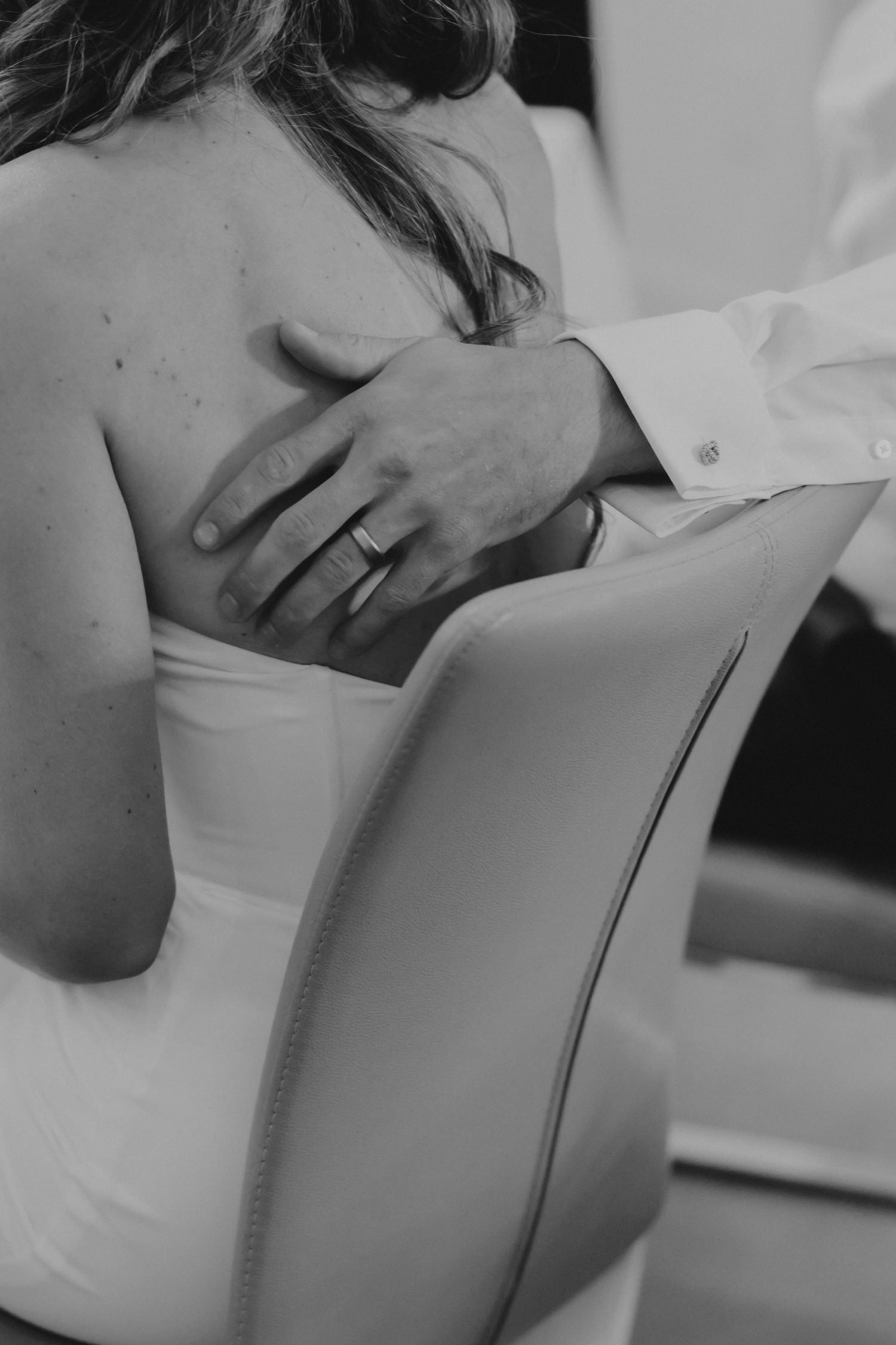 A figure in a white shirt lying down appears to be in a sleeping or resting state in a black and white image.