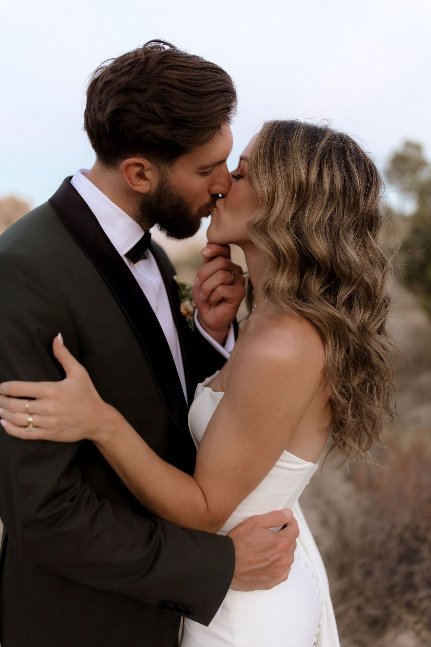 A romantic wedding photo sequence showing intimate close-up moments between a couple embracing and kissing outdoors.