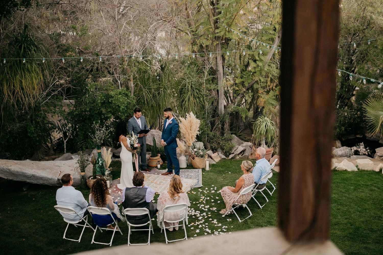 Intimate outdoor wedding ceremony setup with chairs arranged in a garden setting.