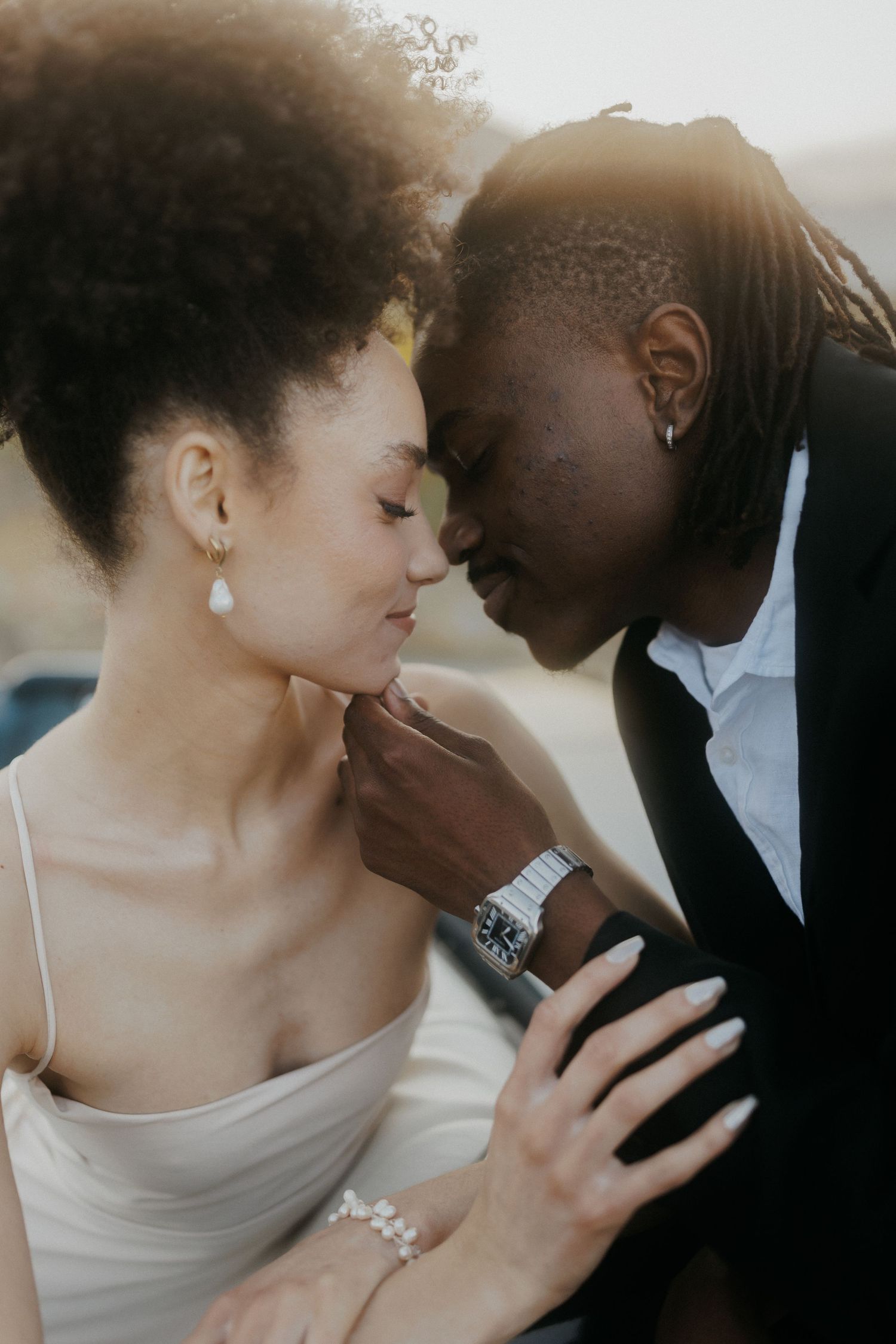 A romantic couple in bridal attire share intimate moments in a series of tender photos.