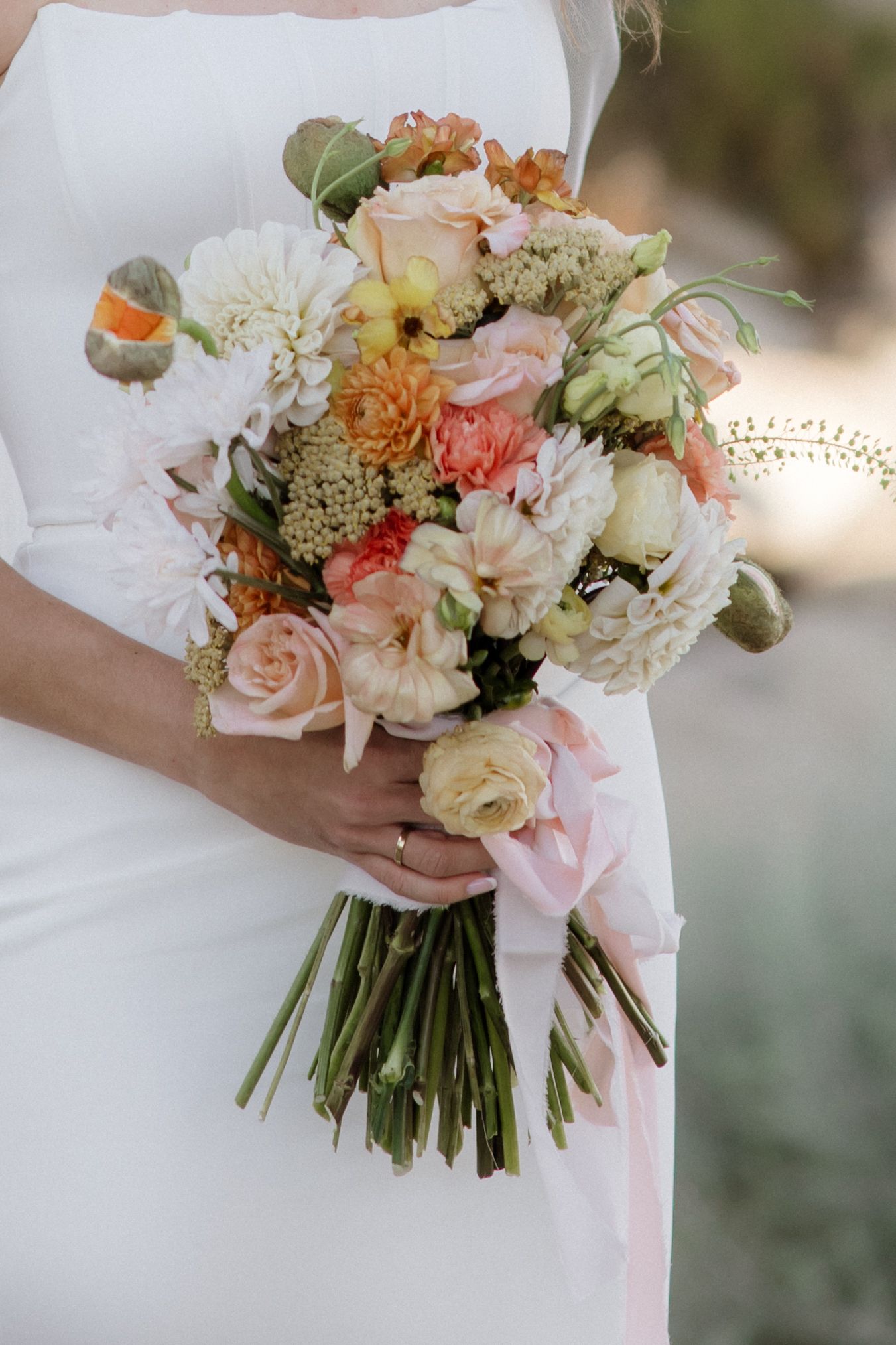 A romantic bridal bouquet with pink and white flowers tied with silk ribbon shown from different angles and perspectives.