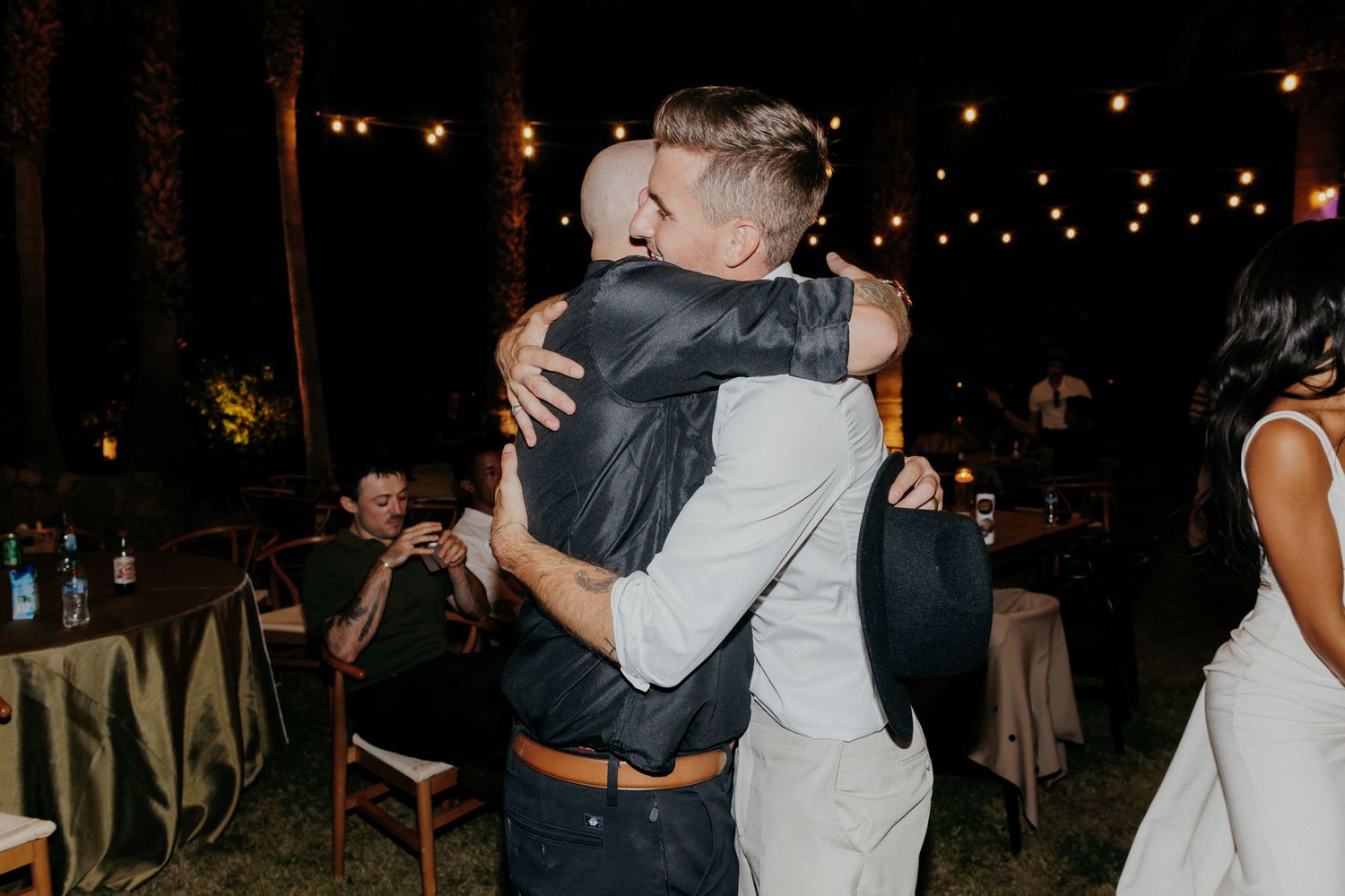 A series of romantic night photos showing couples dancing and embracing at an outdoor wedding reception.