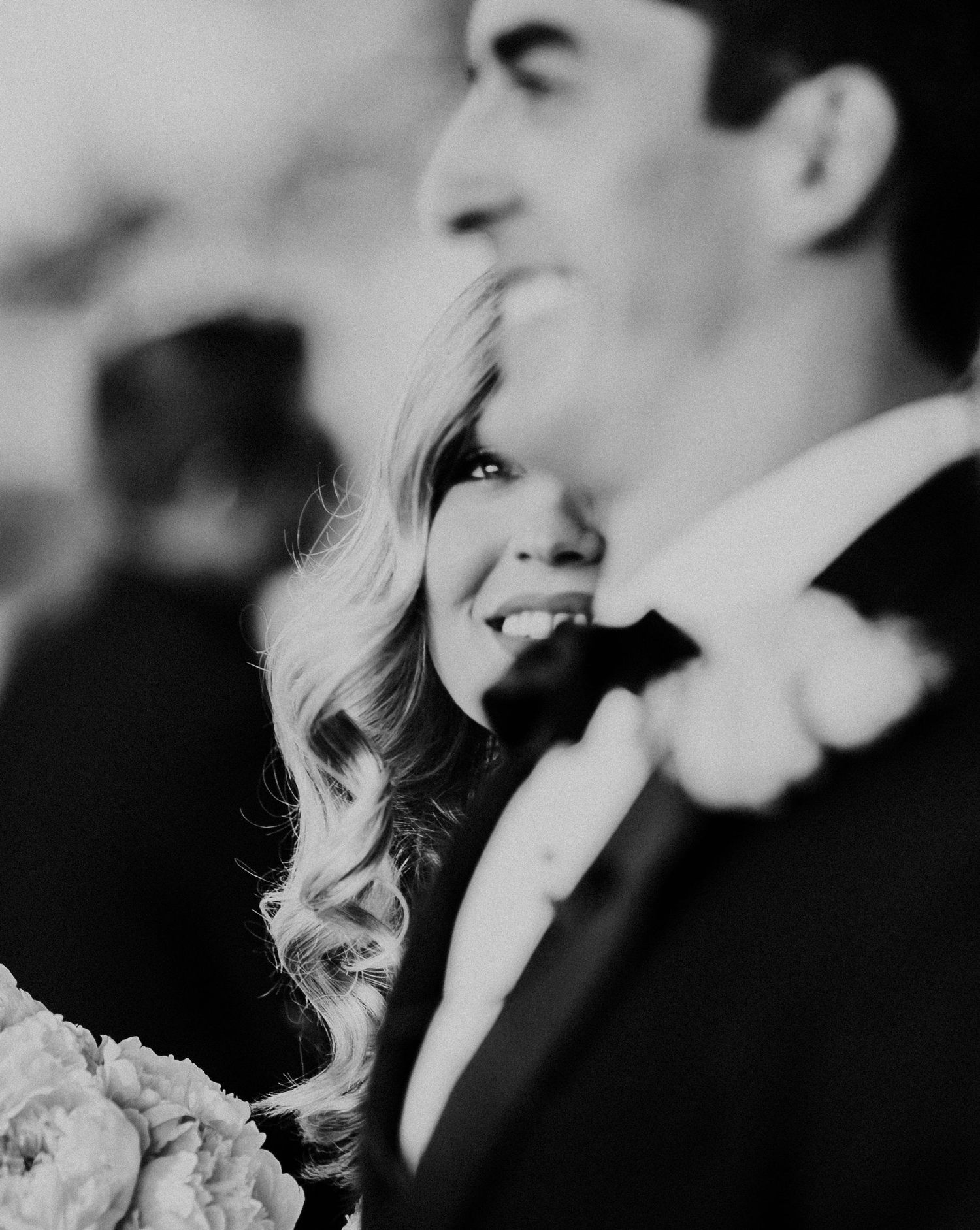Intimate black and white portrait of couple sharing a romantic moment at wedding.