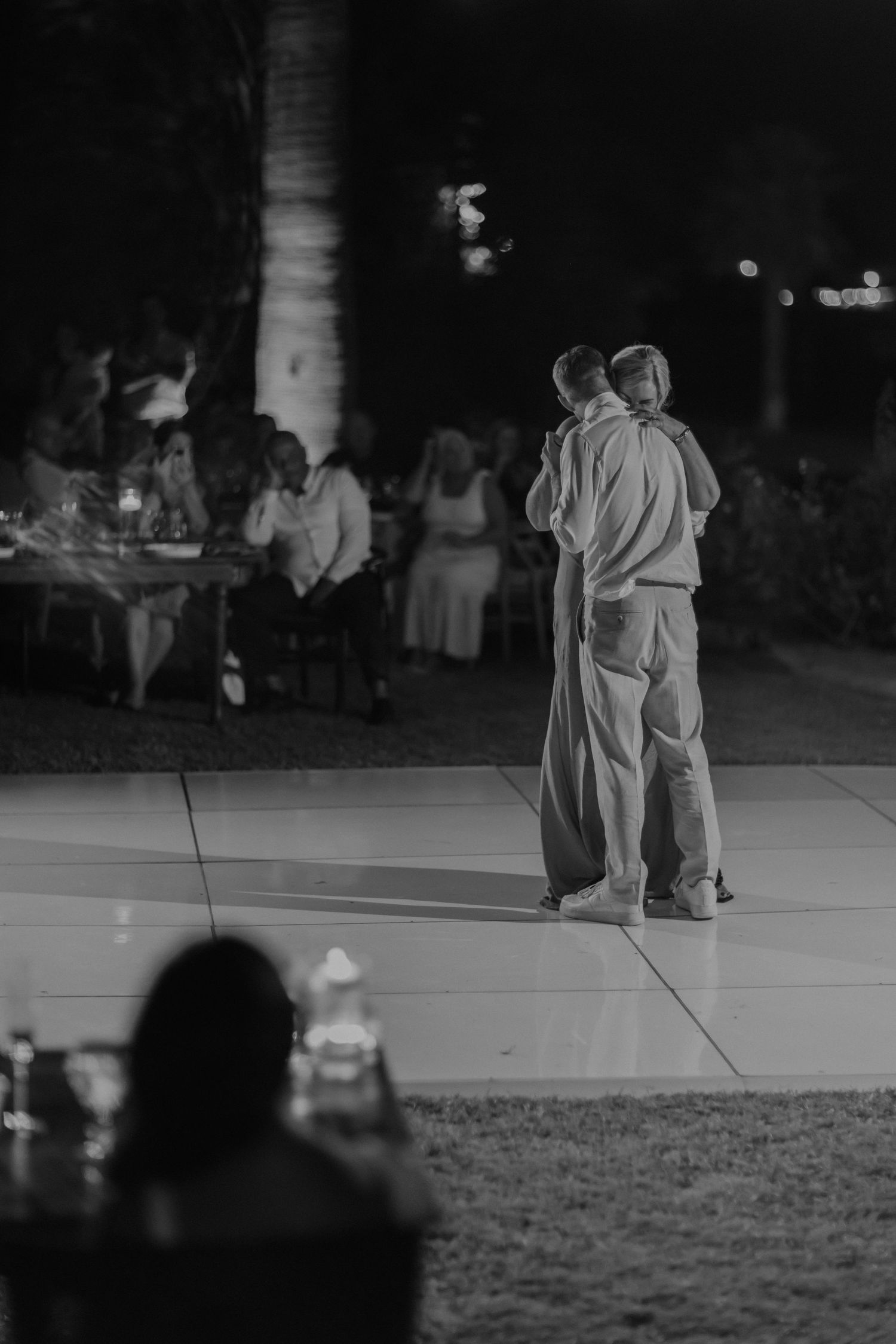 A black and white sequence shows a couple dancing gracefully in an outdoor setting at night.
