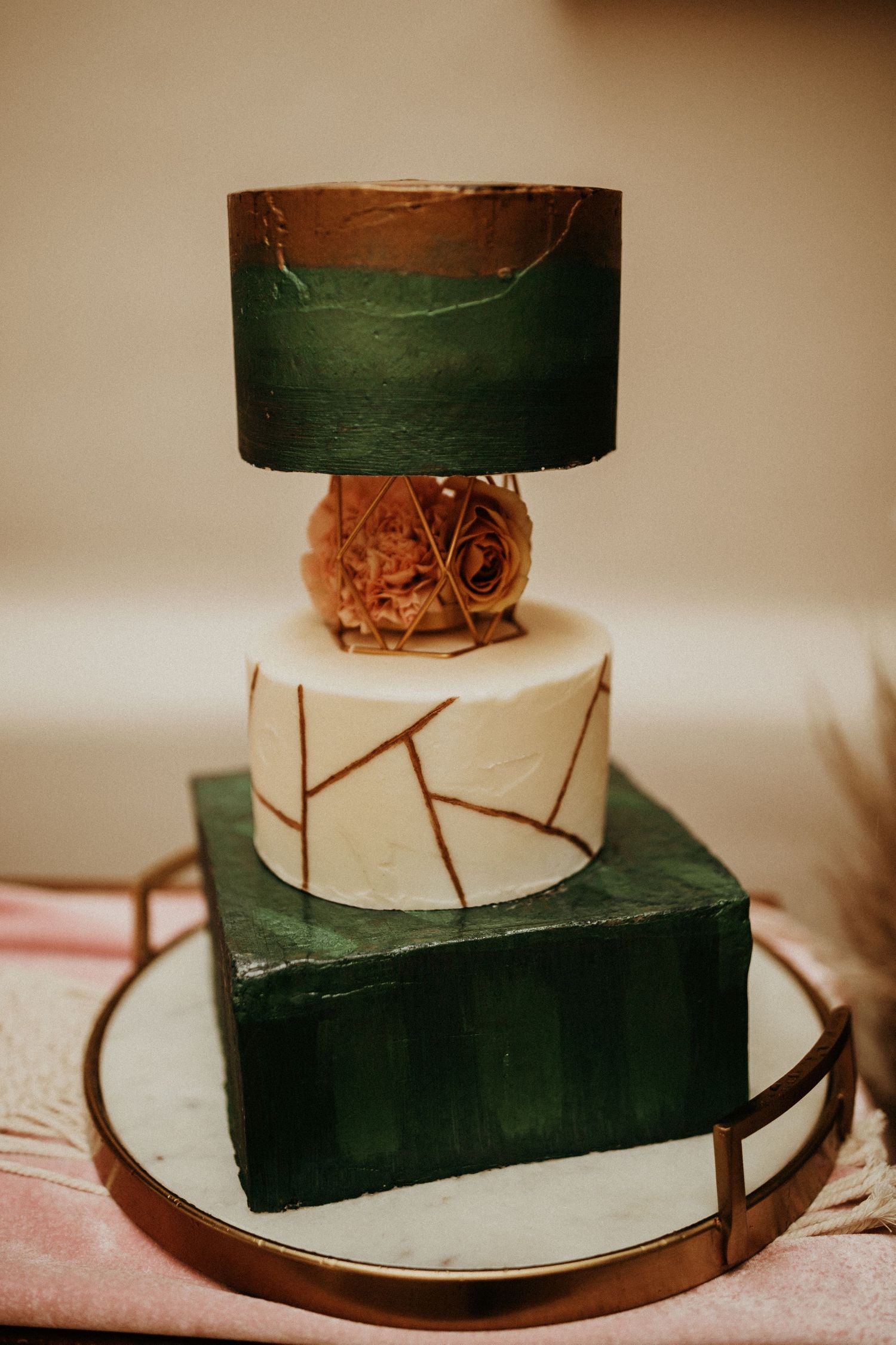 Modern minimalist wedding cake design with geometric black and white tiers.