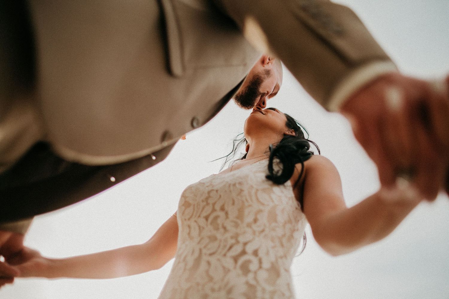 Close-up details of a wedding dress with delicate lace patterns.