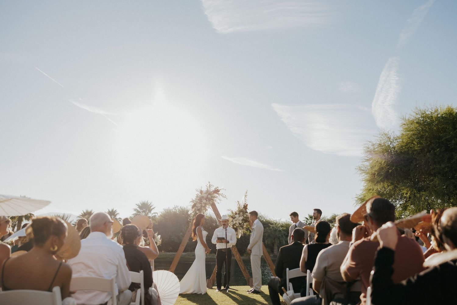A romantic celebration at an outdoor wedding with dancing and sunset lighting creating a magical atmosphere.