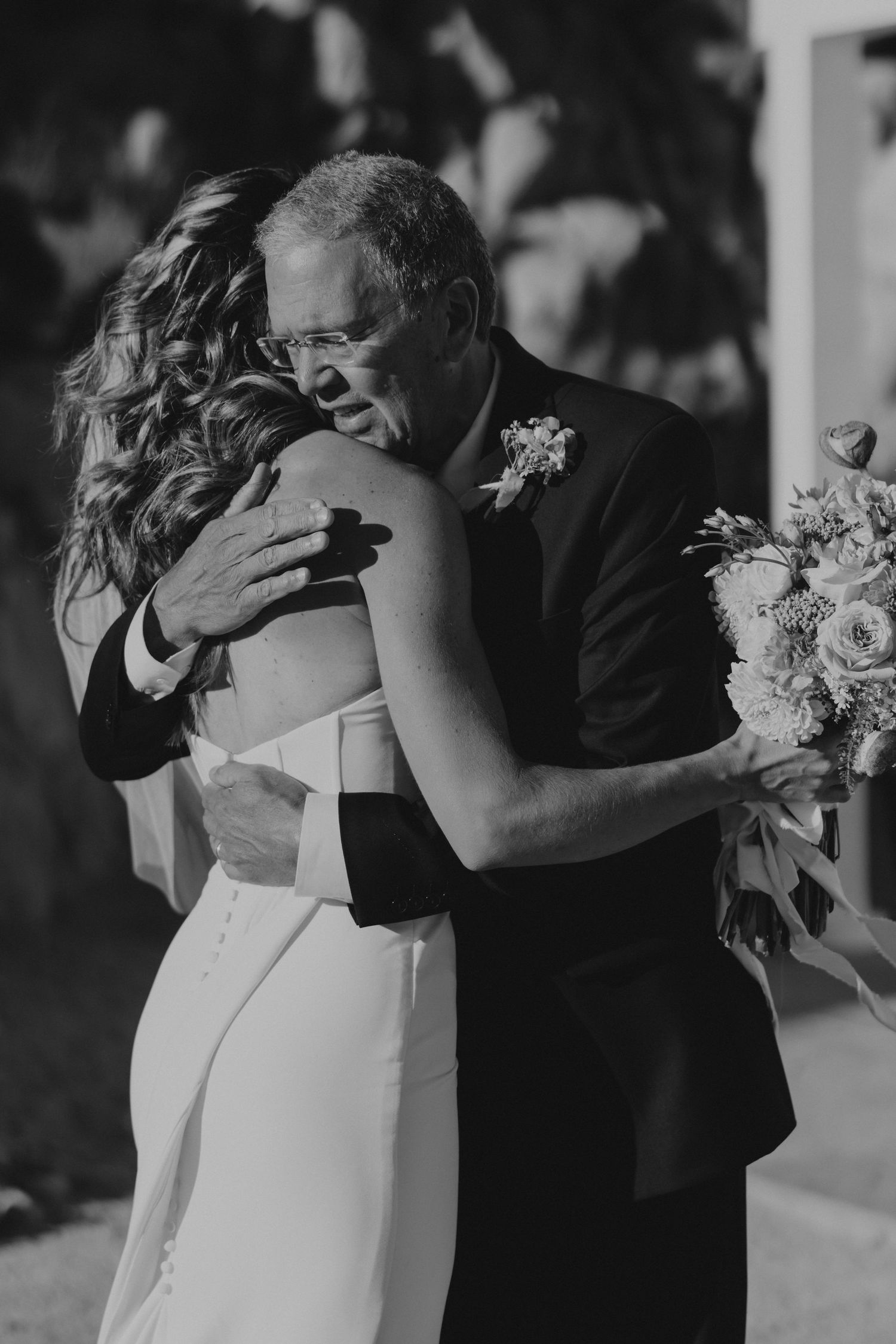 Black and white photos showing an emotional father-daughter dance sequence at a wedding reception.