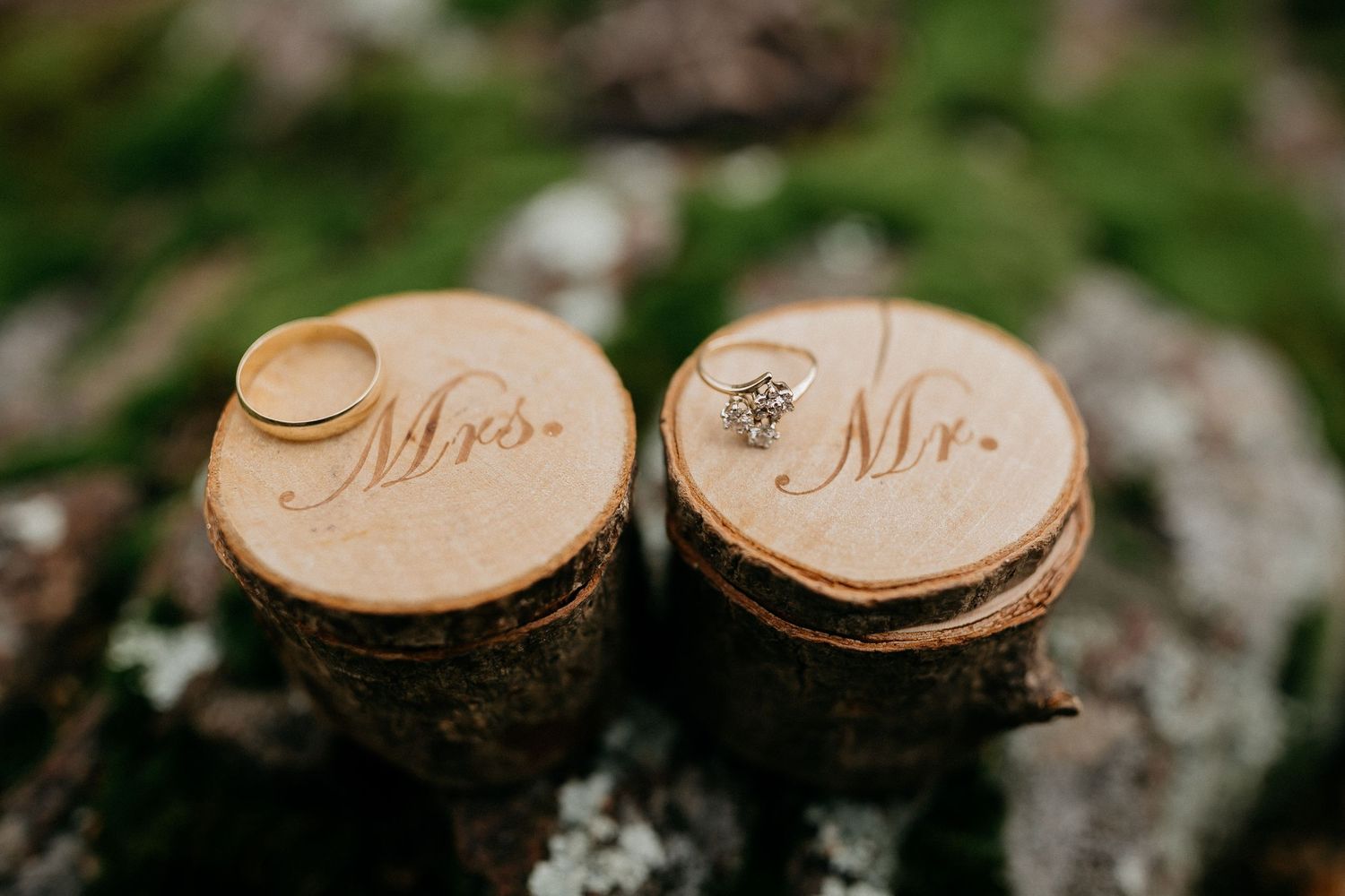 Rustic wooden wedding decor details with Mr and Mrs text burned into wood slices.