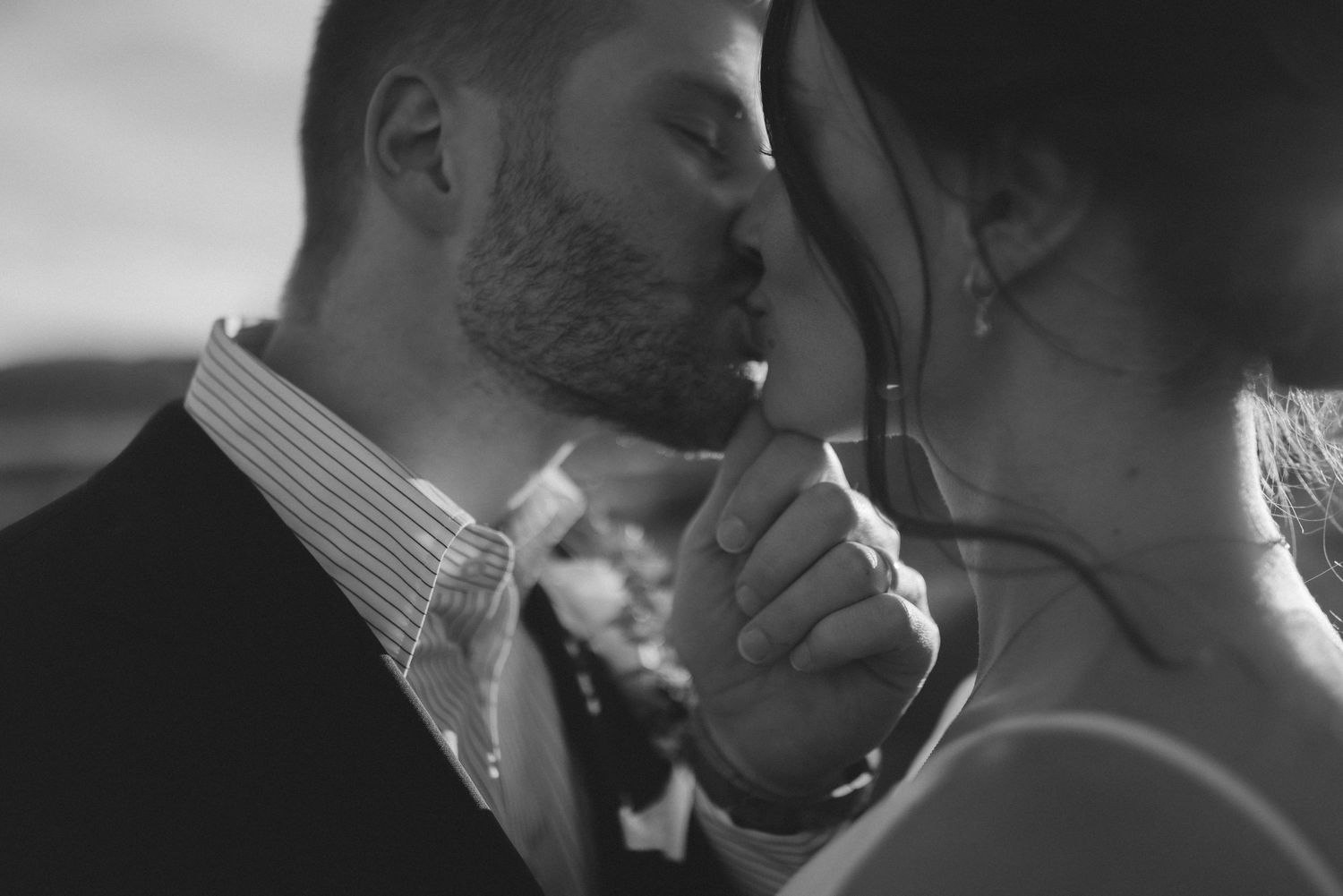 Black and white romantic close-up of couple sharing an intimate moment at their wedding ceremony.