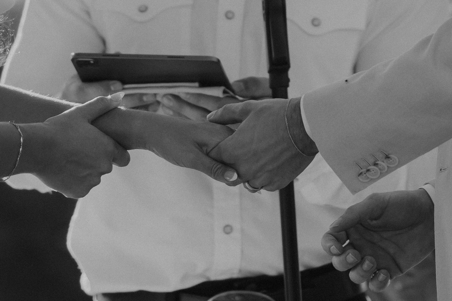 Close-up view of hands passing plates of food and serving food at a banquet or catering event.