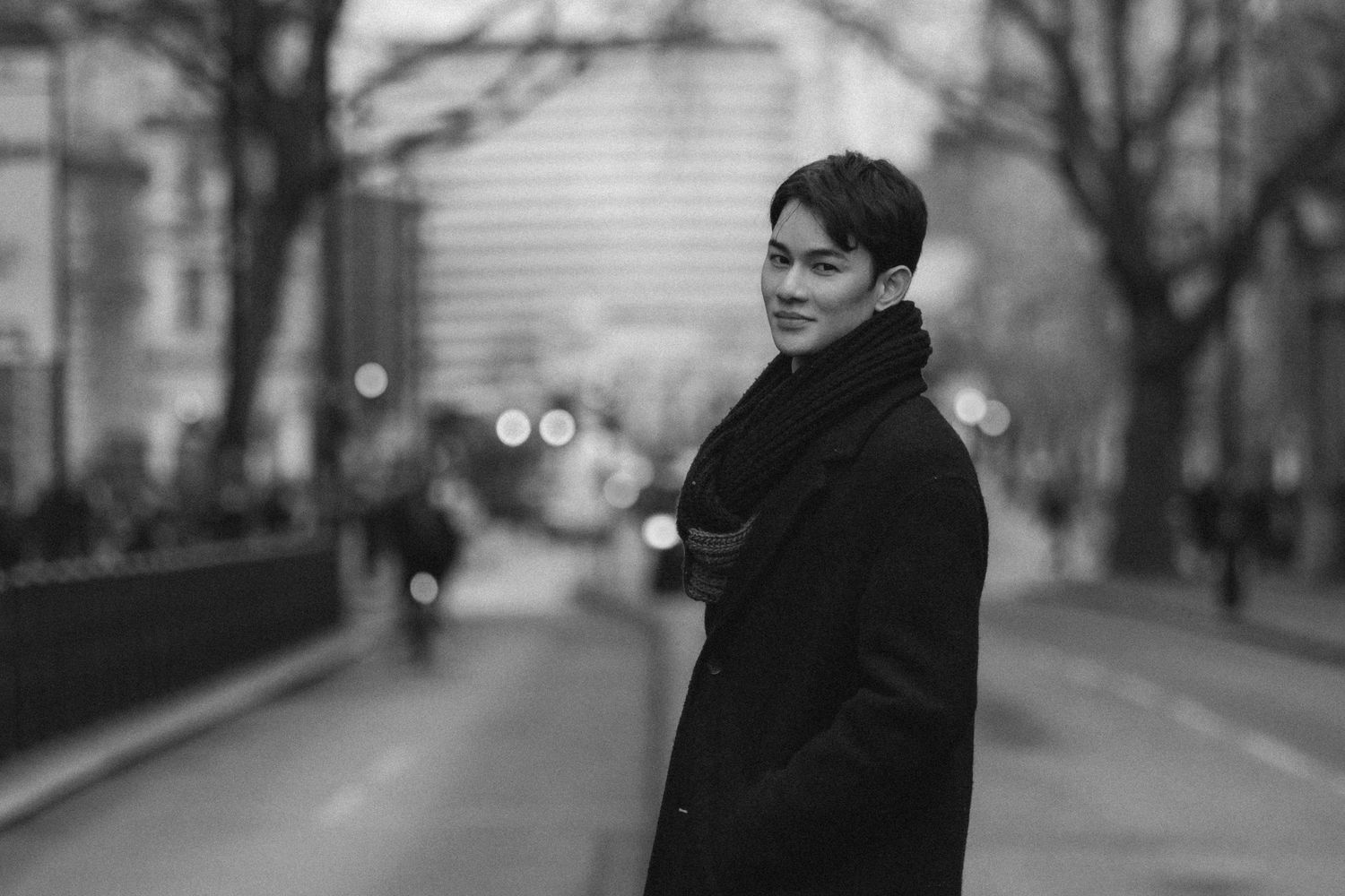 A series of black and white street photographs showing a person in winter clothing on an urban sidewalk.