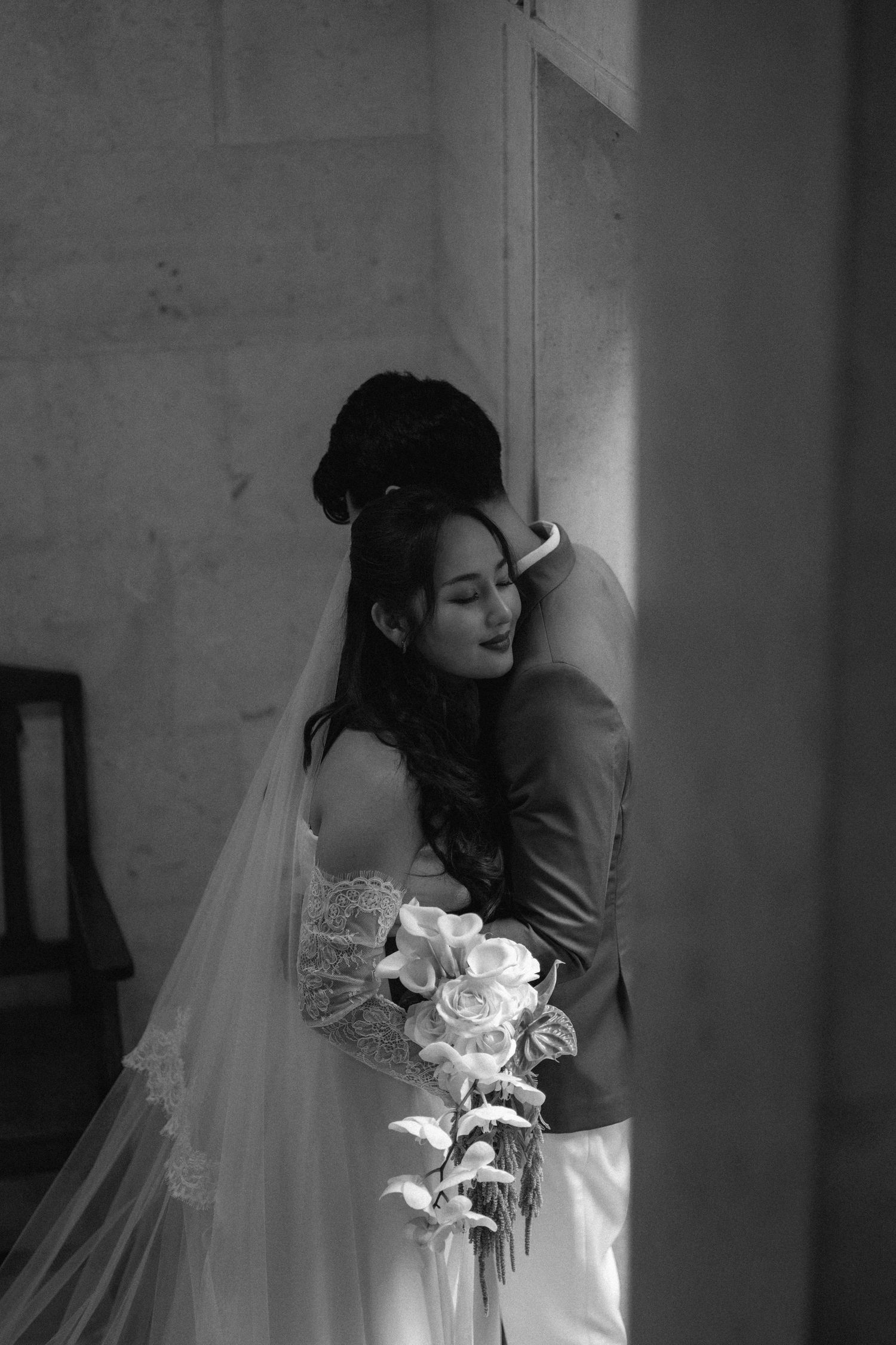 A romantic black and white photo series shows a couple embracing in intimate wedding moments.