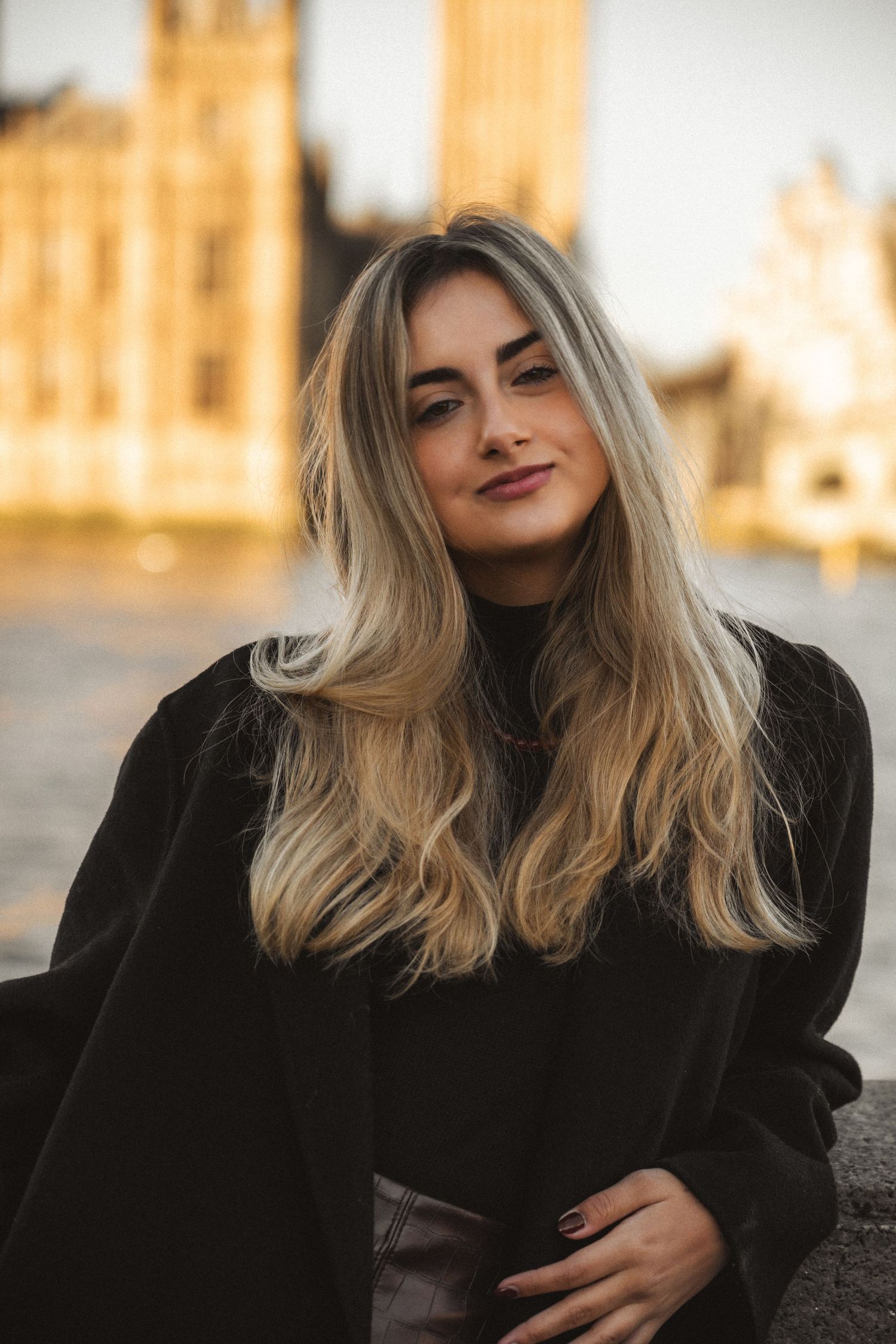 A series of outdoor portraits showing someone with blonde hair wearing black against a warm golden background at sunset.