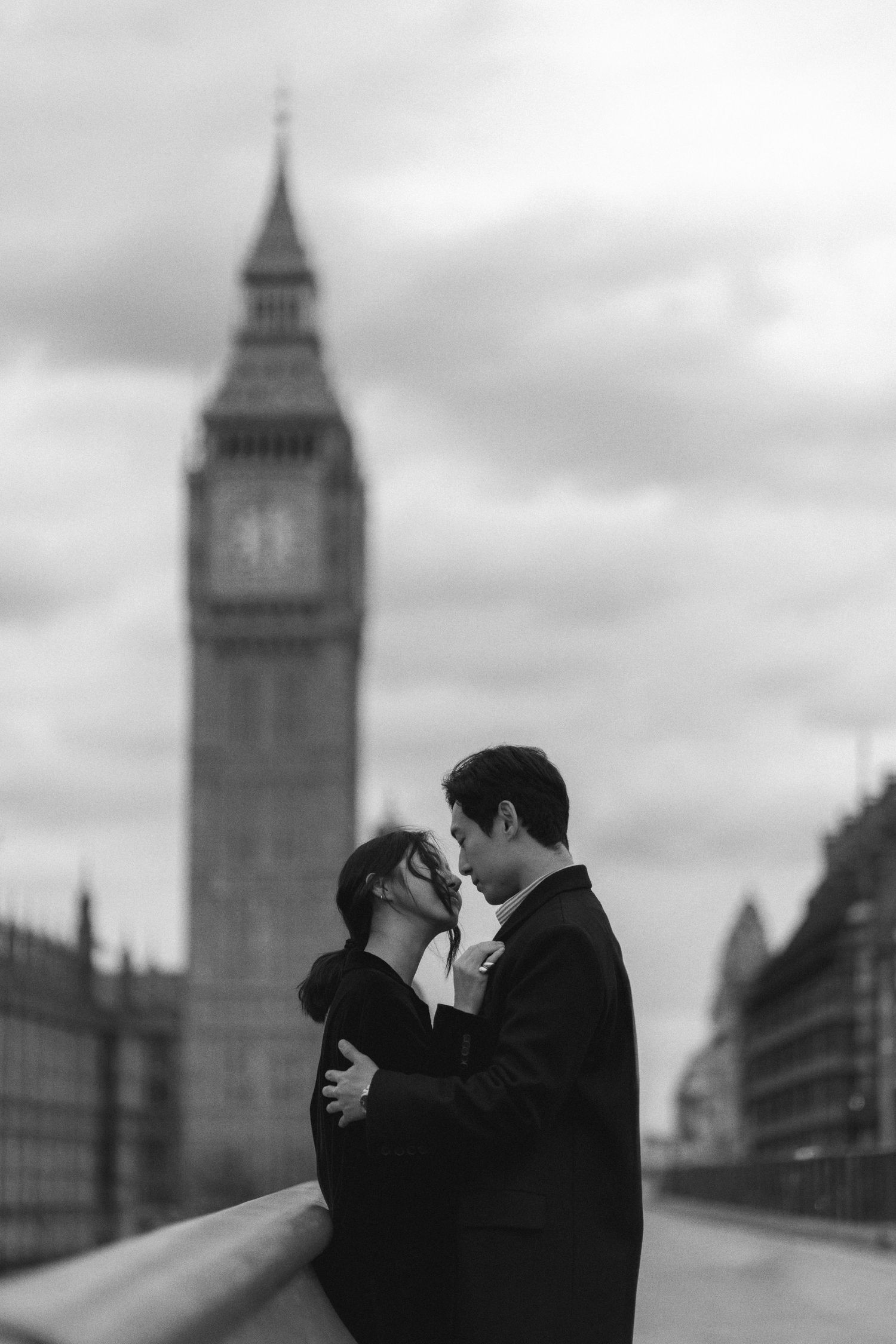 A romantic silhouette of a couple kissing with London's iconic Big Ben tower in the background.